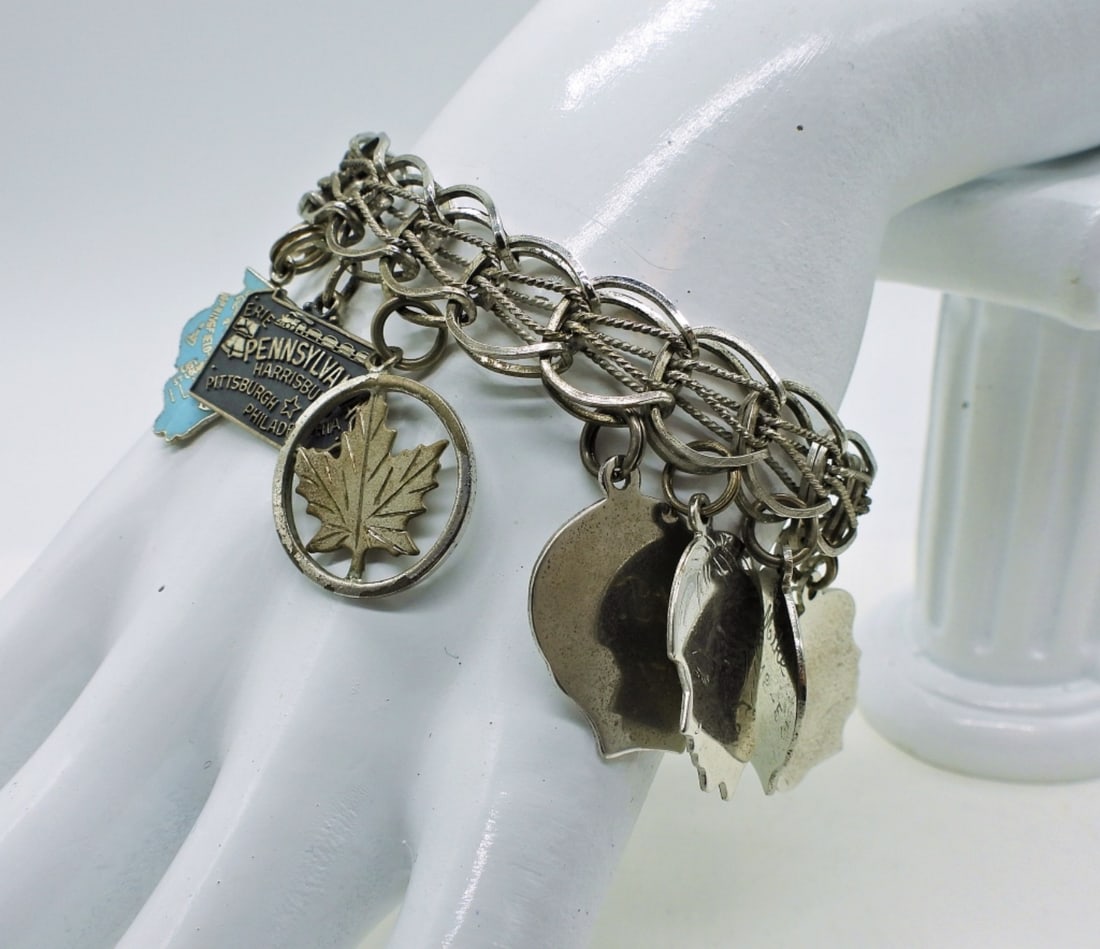 Vintage Sterling Charm Bracelet: Vintage Sterling Charm Bracelet with 12 Charms, 7". Circa late 1950's. 27.6 DWT