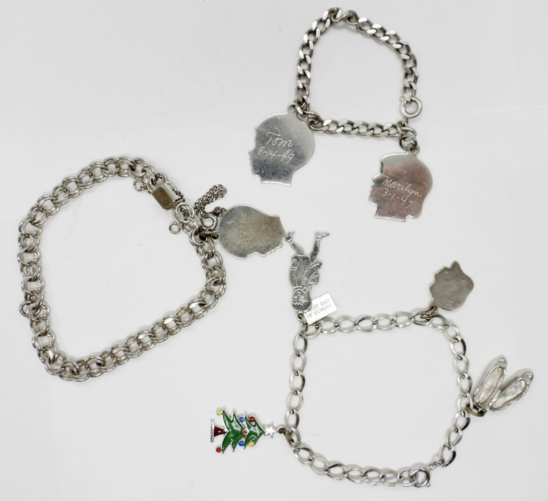 (3) VINTAGE CHARM BRACELETS: 24 DWT. 7", 5" & 7.5" IN LENGTH W/ A TOTAL OF (7) CHARMS MOST STAMPED STERLING.