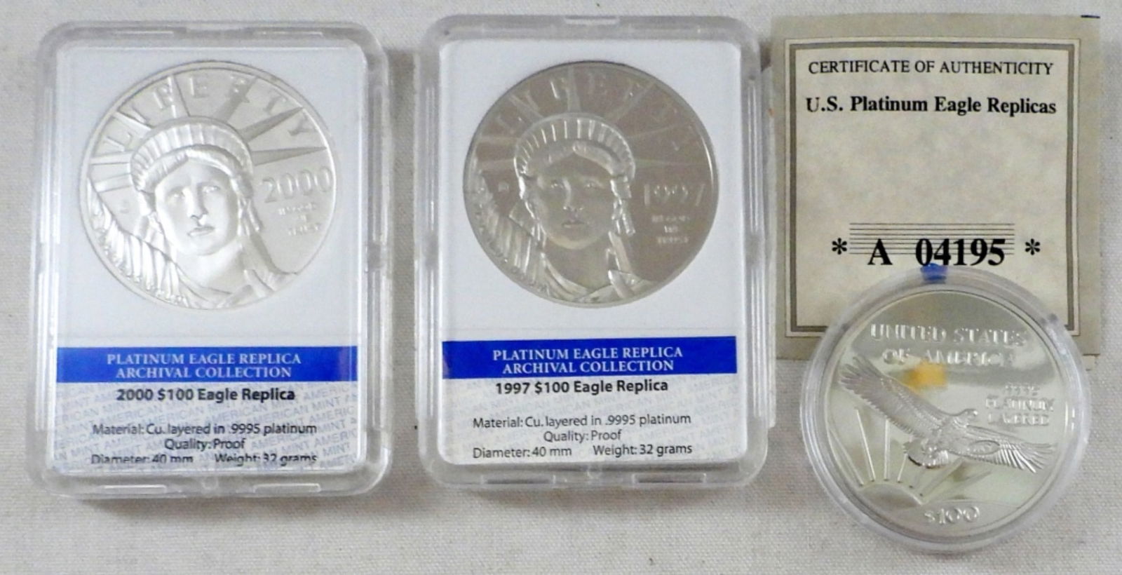 (3) PLATINUM EAGLE REPLICA COINS (1 of 2)
