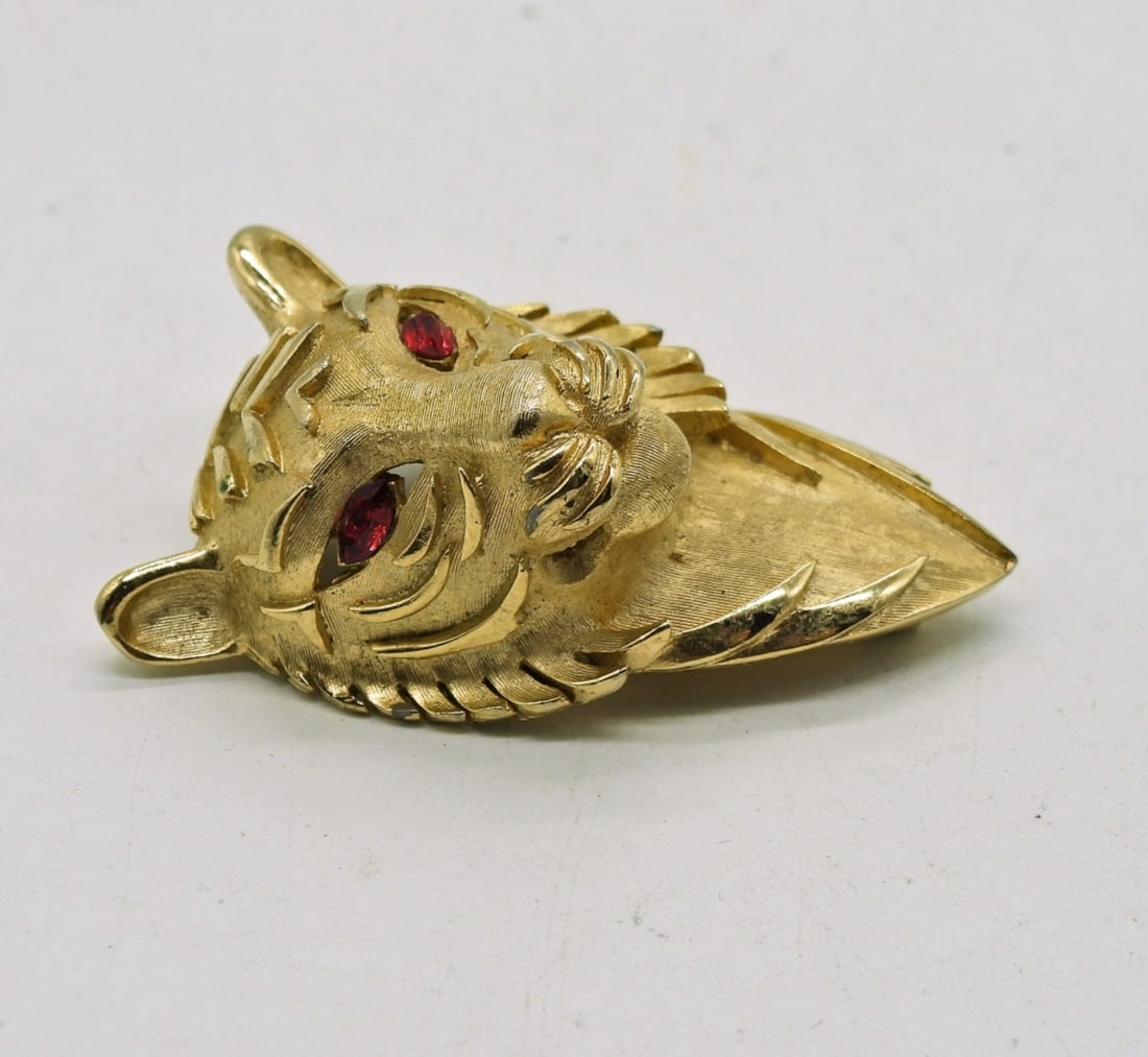 TRIFARI Tiger Brooch: Vintage TRIFARI Gold Tone Tiger Brooch with Red Gemstone Eyes. 2"x 1".