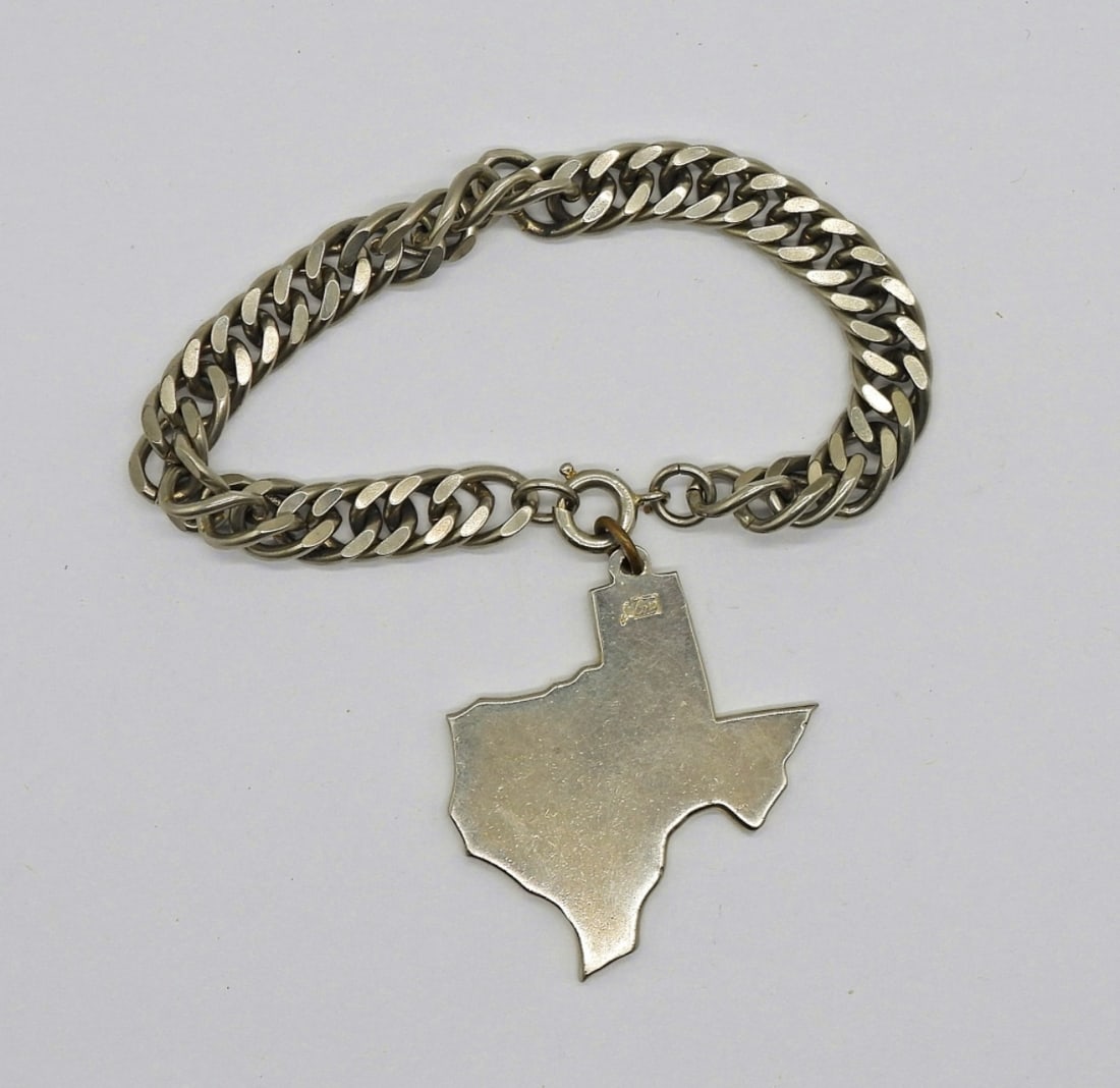 Vintage CORO Texas Pendant Bracelet: Vintage CORO Silver Tone Bracelet, 7". Large Texas Shaped Charm on a Chain Bracelet. Charm Measures 1.5" x 1.5".