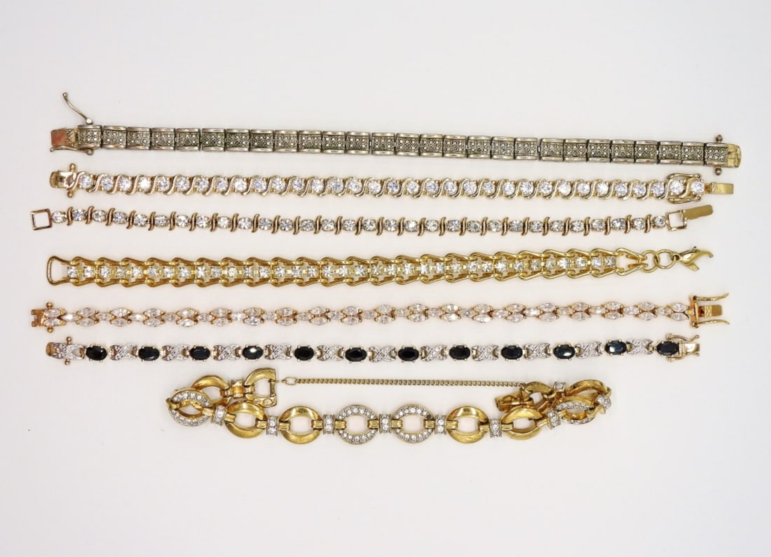 7 GOLD TONE FASHION TENNIS BRACELETS: 7 GOLD TONE FASHION TENNIS BRACELETS WITH WHITE GEMSTONES.
