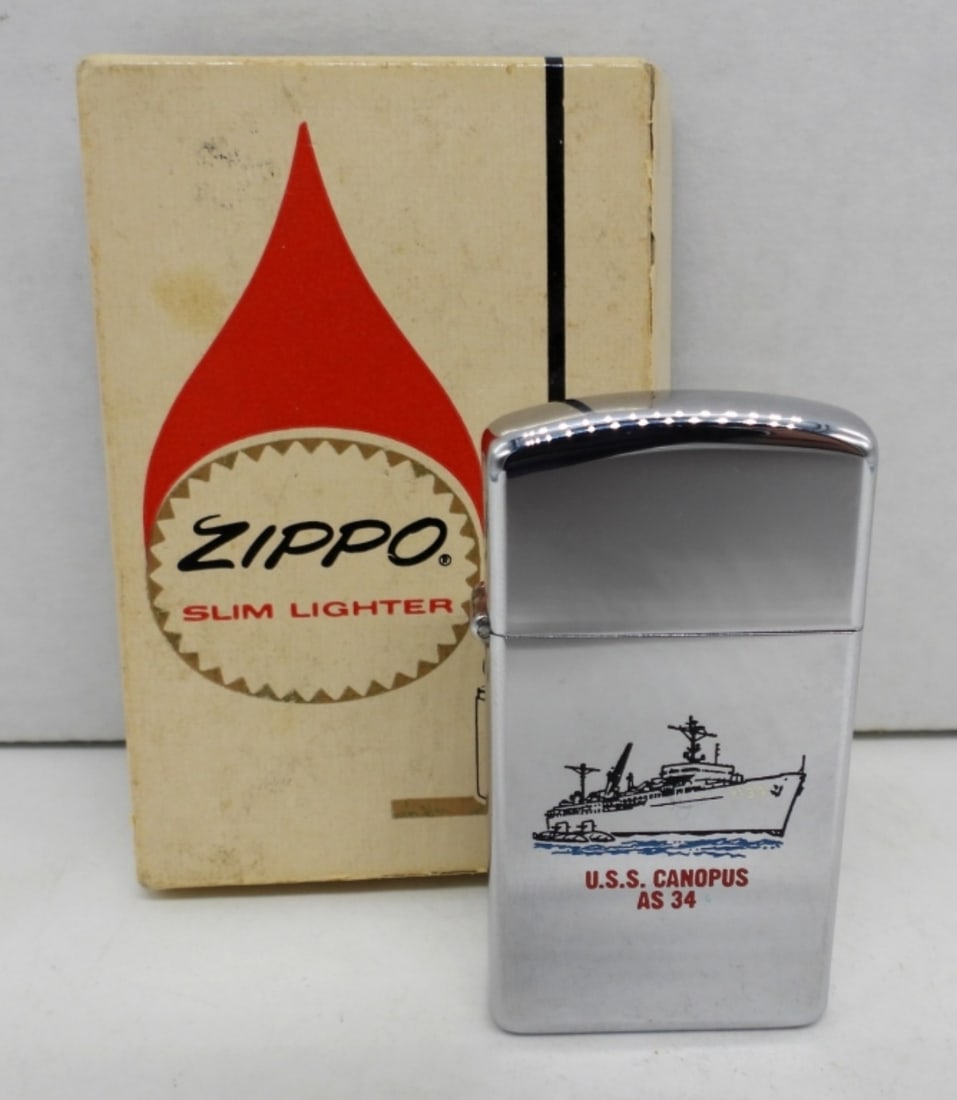 1965 SLIM UNFIRED U.S.S CANOPUS AS 34: UNFIRED, SHIP WITH U.S.S. CANOPUS AS 34, WITH LOGO ON THE BACK, IN A ZIPPO BOX(FLAPS ON BOX ARE APART ON ONE SIDE)