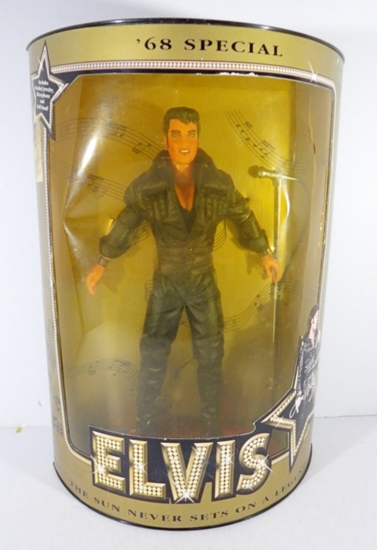 1993 HASBRO ELVIS '68 SPECIAL IN BOX: THE CELLO IS CRACKED ON THE FRONT, DOLL IS STILL IN GREAT CONDITION, AND INCLUDES DETAILED JEWELRY, A MICROPHONE, AND DOLL STAND