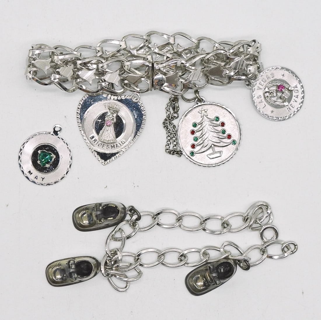2 VTG STERLING CHARM BRACELETS: TWO VINTAGE STERLING CHARM BRACELETS WITH 7 CHARMS BETWEEN THEM. BOTH 7". 28.9 DWT