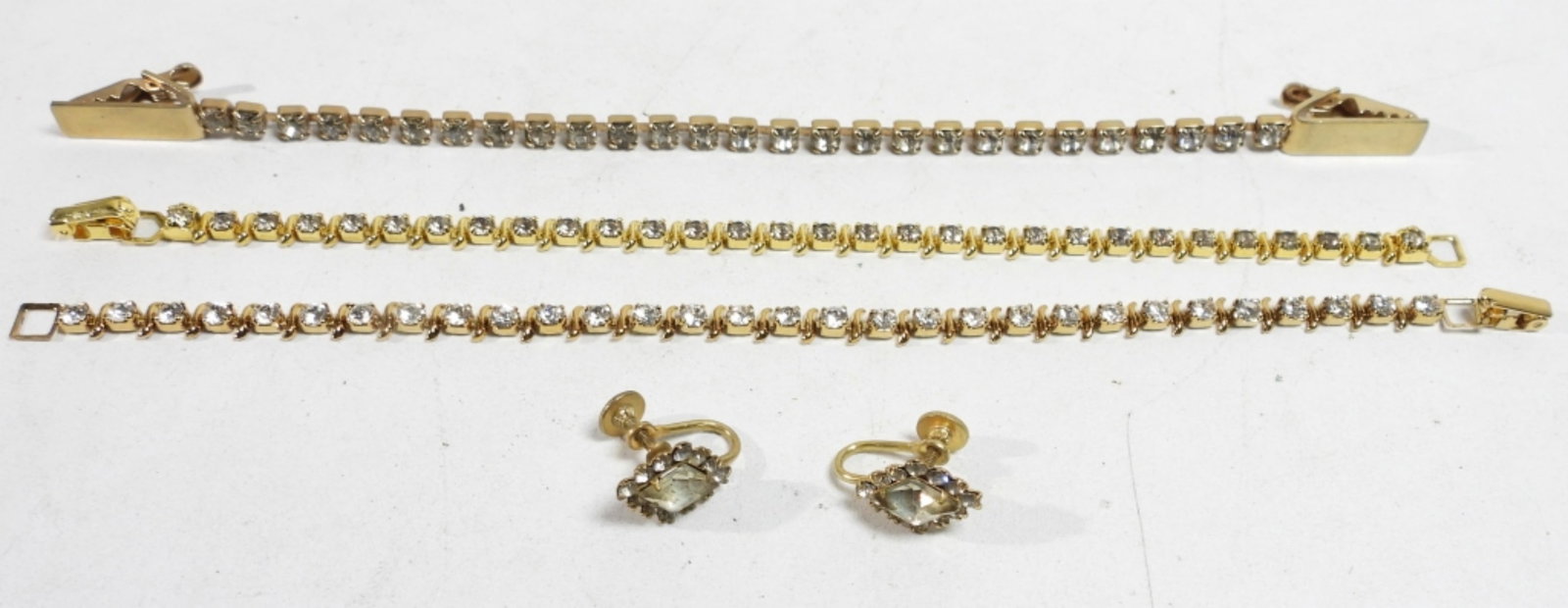 GOLD TONE RHINESTONE LOT - SCREW BACK: EARRINGS, (2) 7" BRACELETS (1) SWEATER CLAMP