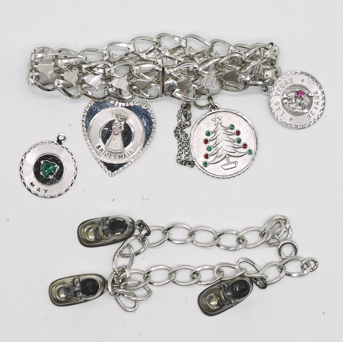 2 VTG STERLING CHARM BRACELETS: TWO VINTAGE STERLING CHARM BRACELETS WITH 7 CHARMS BETWEEN THEM. BOTH 7". 28.9 DWT