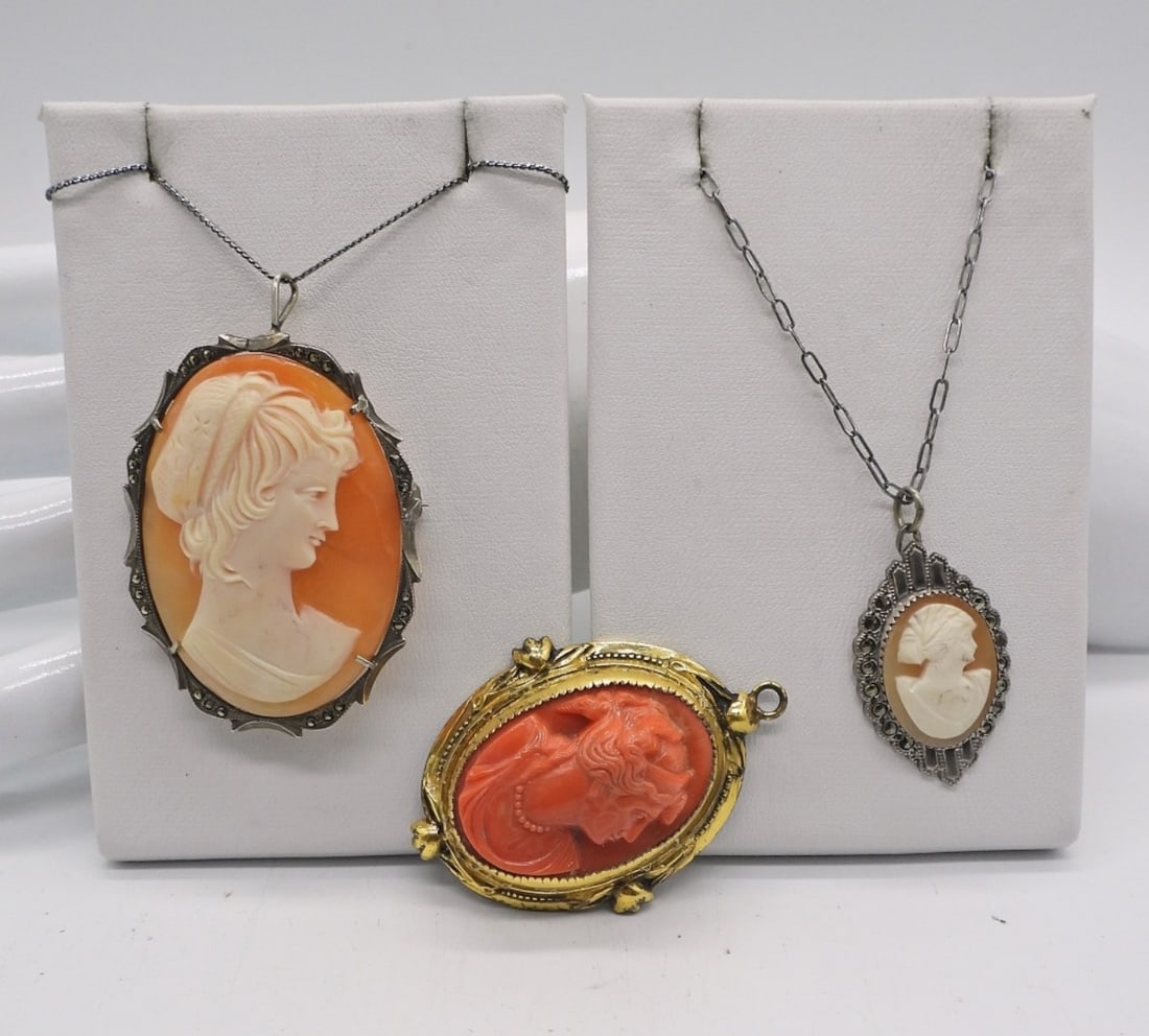 3 VINTAGE 925 CAMEOS CORO: LARGE STERLING CAMEO MARCASITE PENDANT (2"x1.5") ON A 19" STERLING CHAIN. SMALLER STERLING CAMEO MARCASITE PENDANT ON A VINTAGE 15" STERLING CHAIN. A CORO BRAND GOLD TONE STERLING PENDANT WITH A RED C