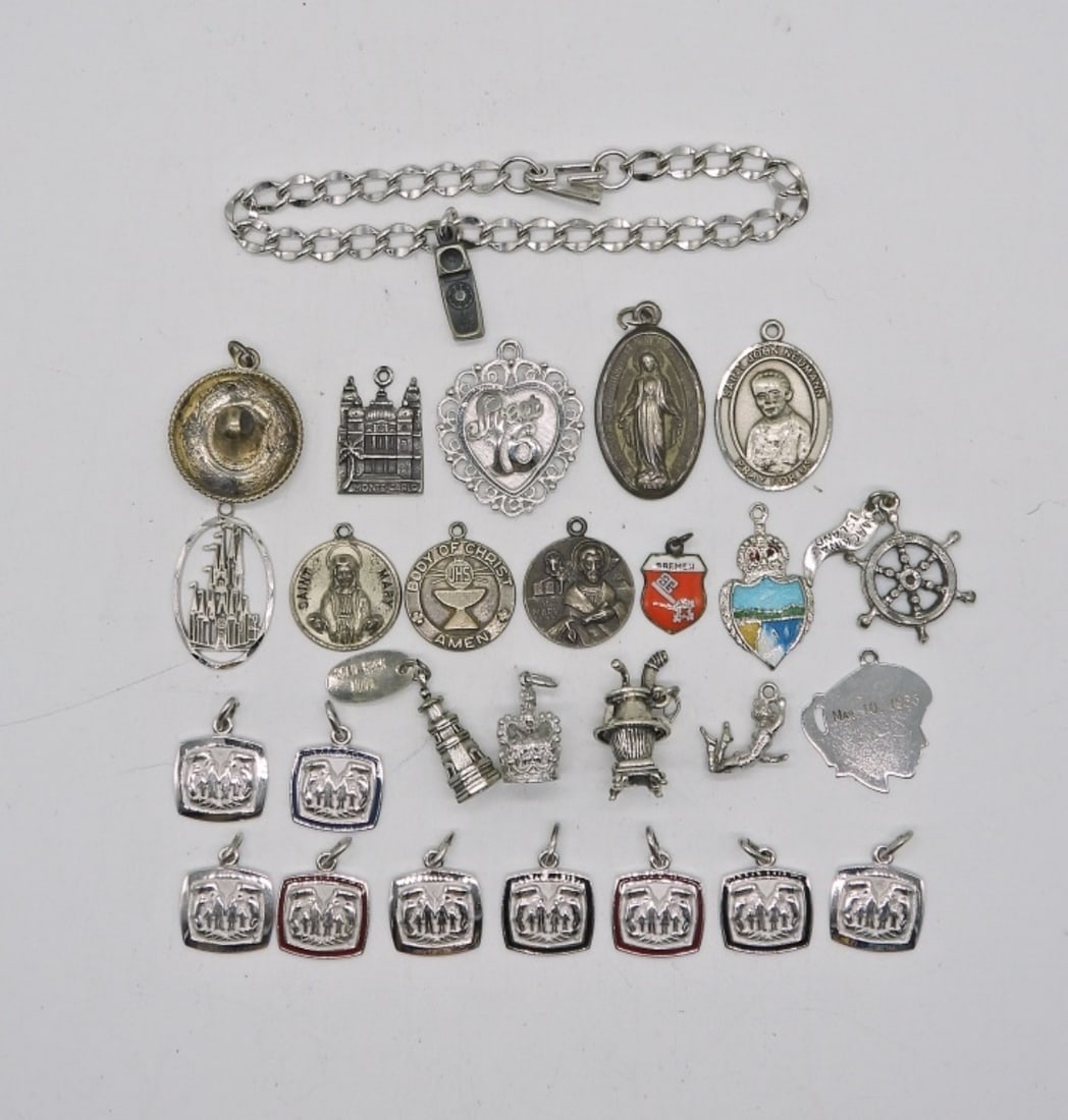 27 STERLING CHARMS & BRACELET: STERLING CHARM BRACELET WITH 27 VINTAGE STERLING CHARMS. BRACELET IS 7". 65.7 DWT