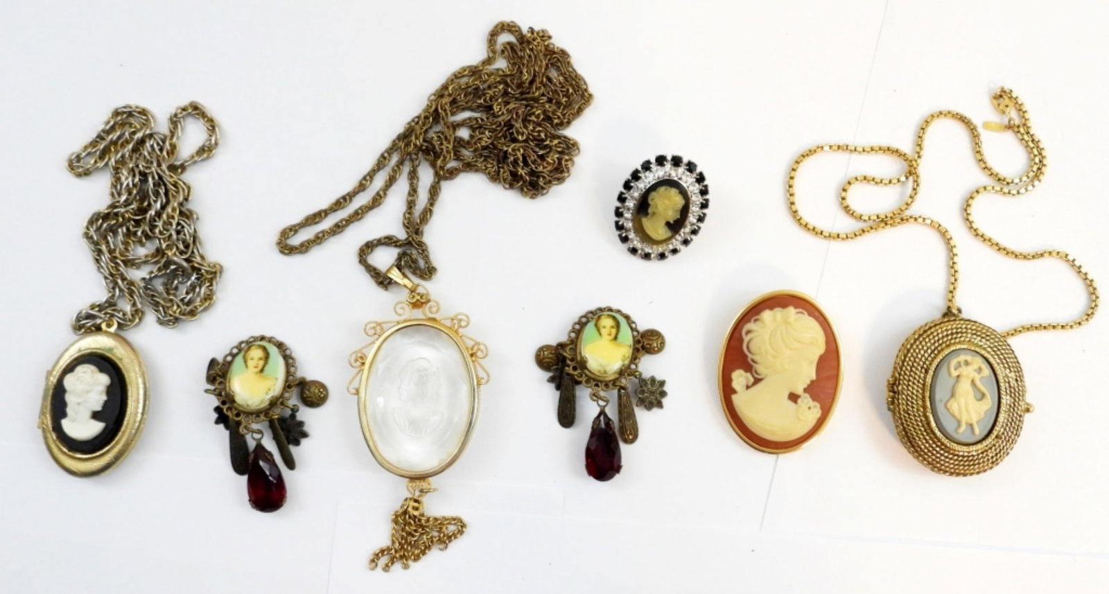 6 VINTAGE CAMEO PIECES: 1 VINTAGE CAMEO PERFUME LOCKET NECKLACE16" ,2 VINTAGE CAMEO NECKLACE 24", A CAMEO BROOCH,A VINTAGE BLACK CAMEO RING, AND A SET OF CSMRO EARRINGS