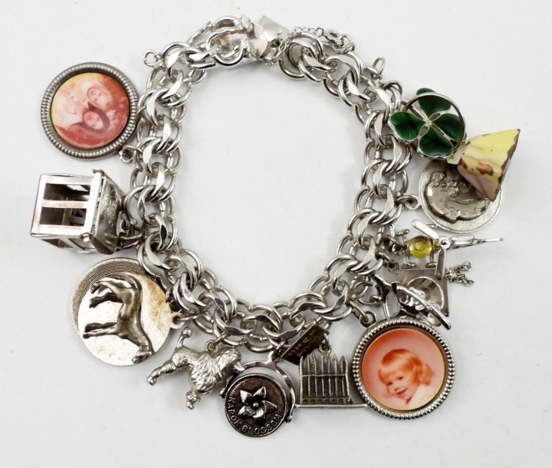 6IN STERLING CHARM BRACELET: 6IN STERLING CHARM BRACELET WITH 15 CHARMS ( MOST ARE STERLING )45.6 DWT