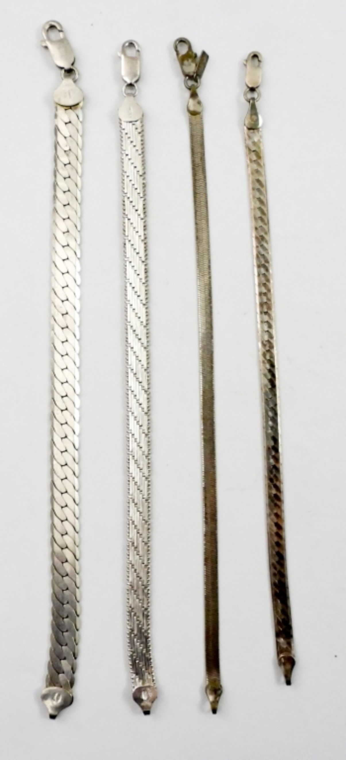 (4) STERLING BRACELETS: 28 DWT. (3) STAMPED ITALY 925. LENGTHS: 8", 7.5", 7", 7.5"