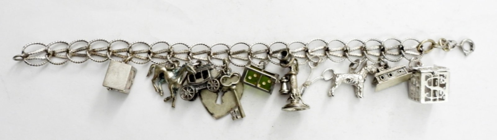 8IN STERLING CHARM BRACELET w/ 10 CHARMS: 8IN STERLING CHARM BRACELET w/ 10 CHARMS.26.1 DWT