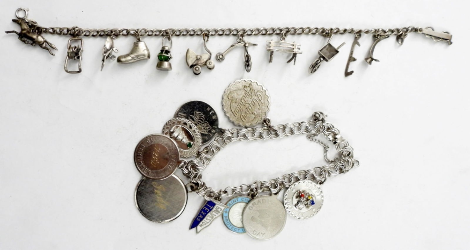 (2) VINTAGE STERLING CHARM BRACELETS: (2) VINTAGE STERLING CHARM BRACELETS,21 CHARMS TOTAL.31.4 DWT