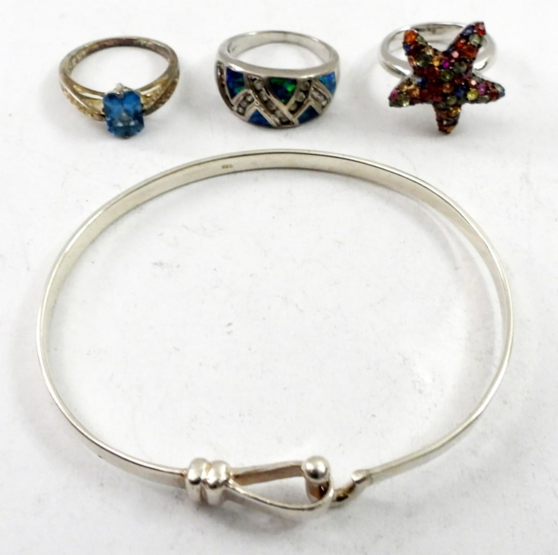 3 STERLING RINGS & BRACELET: 3 STERLING RINGS SIZE 8,&7 VARIOUS COLORED STONES AND STERLING BANGLE BRACELET.16.5 DWT