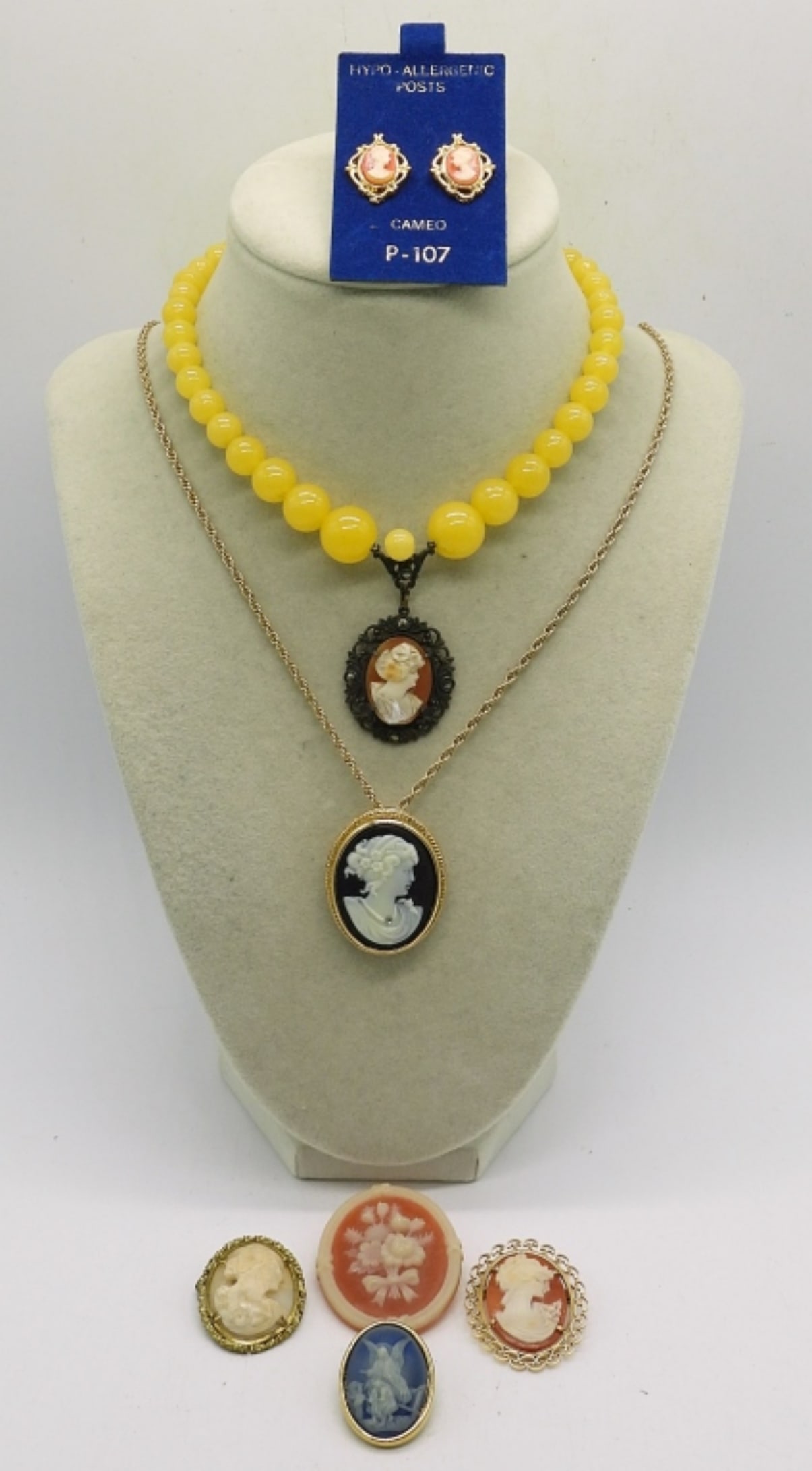 (7) CAMEO PIECES: 2 CAMEO NECKLACES, 12 & 24". 4 CAMEO BROOCHES. ONE PAIR OF PIERCED CAMEO EARRINGS.