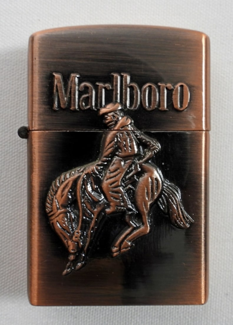BRASS MARLBORO COWBOY BUTANE ZIPPO: VINTAGE BRASS MARLBORO COWBOY BUCKING BRONCO BUTANE ZIPPO. (DATE NOT FOUND) IN MARLBORO BOX