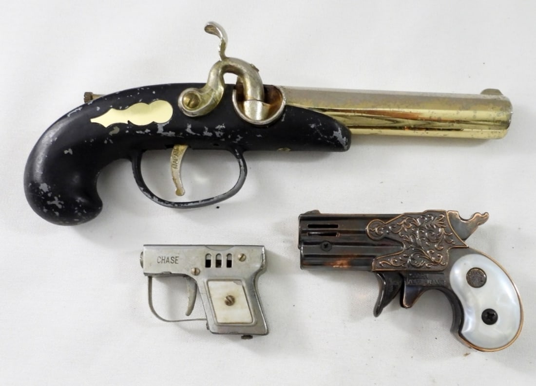 (3) PISTOL SHAPED LIGHTERS: (3) PISTOL-SHAPED LIGHTERS (1) BLACK AND GOLD FLINTLOCK LIGHTER PARTS & REPAIR, (1) CHASE HANDGUN LIGHTER WORN CONDITION (1) MODERN ANGEL MASCOT PISTOL LIGHTER GOOD CONDITION