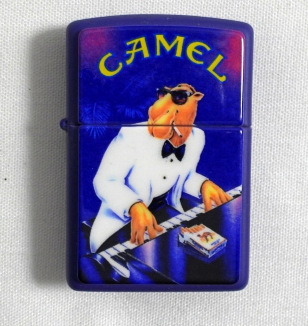 1997 (SEALED/UNFIRED) PURPLE CAMEL ZIPPO: 1997 (SEALED/UNFIRED) PURPLE CAMEL JOE PIANO PLAYER ZIPPO IN CASE