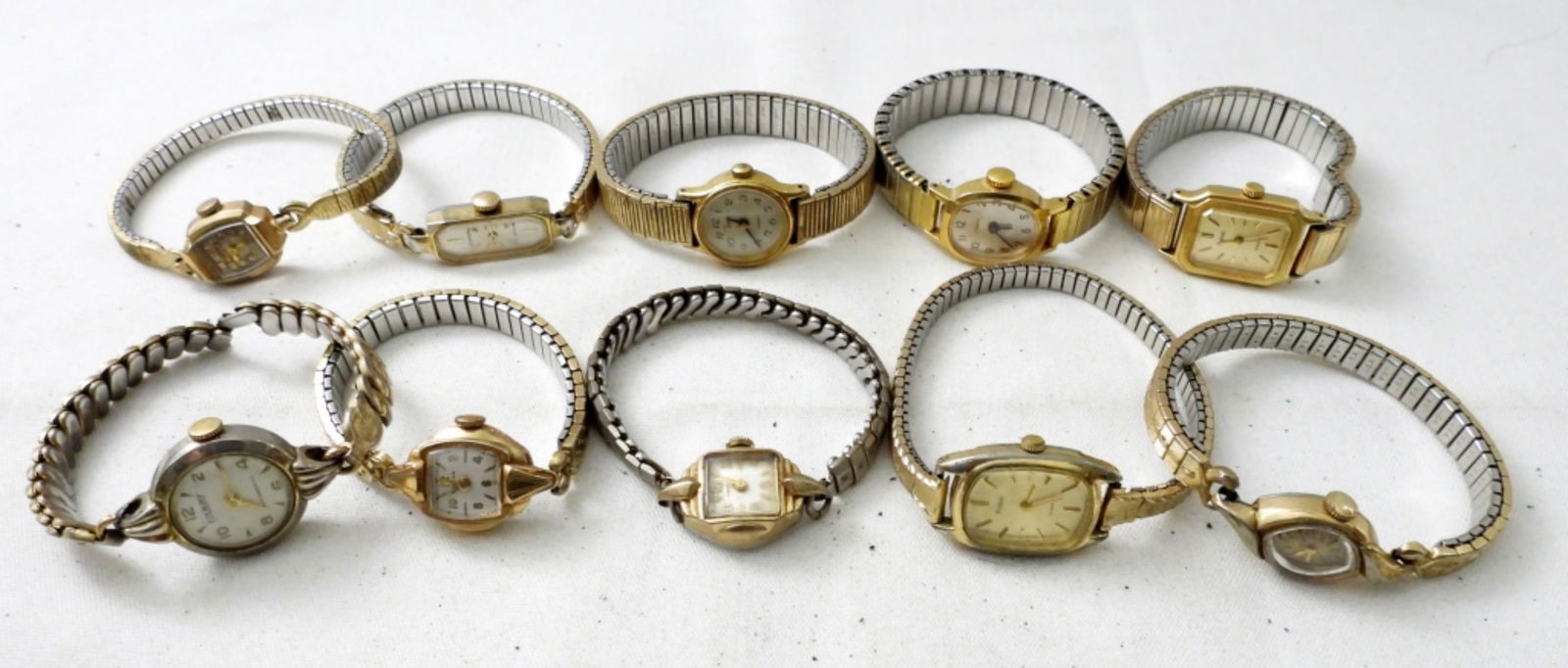 (10) VINTAGE LADIES WATCHES: (10) VINTAGE LADIES WATCHES ,BUKOVA,PULSAR ,TIMEX & MORE. ALL WITH STRETCHY BANDS , ALL GOLD TONE . NOT TESTED AS TO WORKING OR NOT