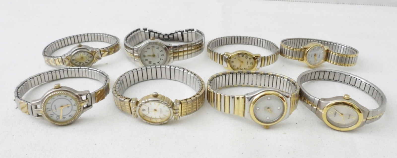 (8) 2-TONE STRETCHY BAND LADIES WATCHES: (8) 2-TONE STRETCHY BAND LADIES WATCHES,QUARTS, TIMEX, MILAN & MORE .BOTH GOLD AND SILVER TONE . NOT TESTED AS TO WORKING OR NOT