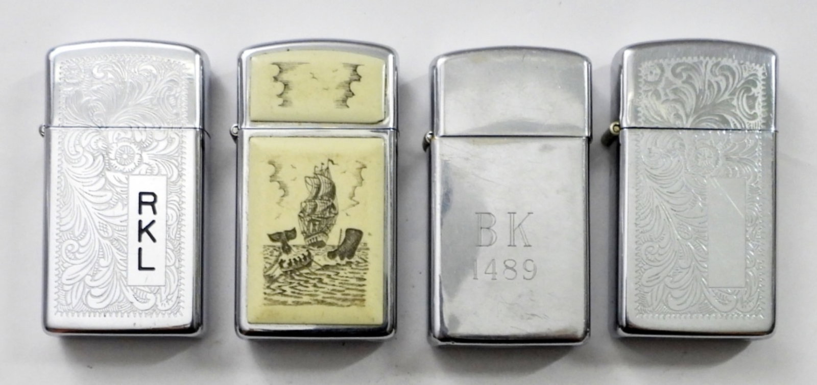 (4) FIRED SLIM ZIPPO LIGHTERS: (4) FIRED SLIM ZIPPO LIGHTERS.1985 SCRIMSHAW SHIP EMBLEM,1980 FLORENTINE/ VENETIAN DESIGN,1986 FLORENTINE / VENETIAN DESIGN,1989 CHROME ZIPPO