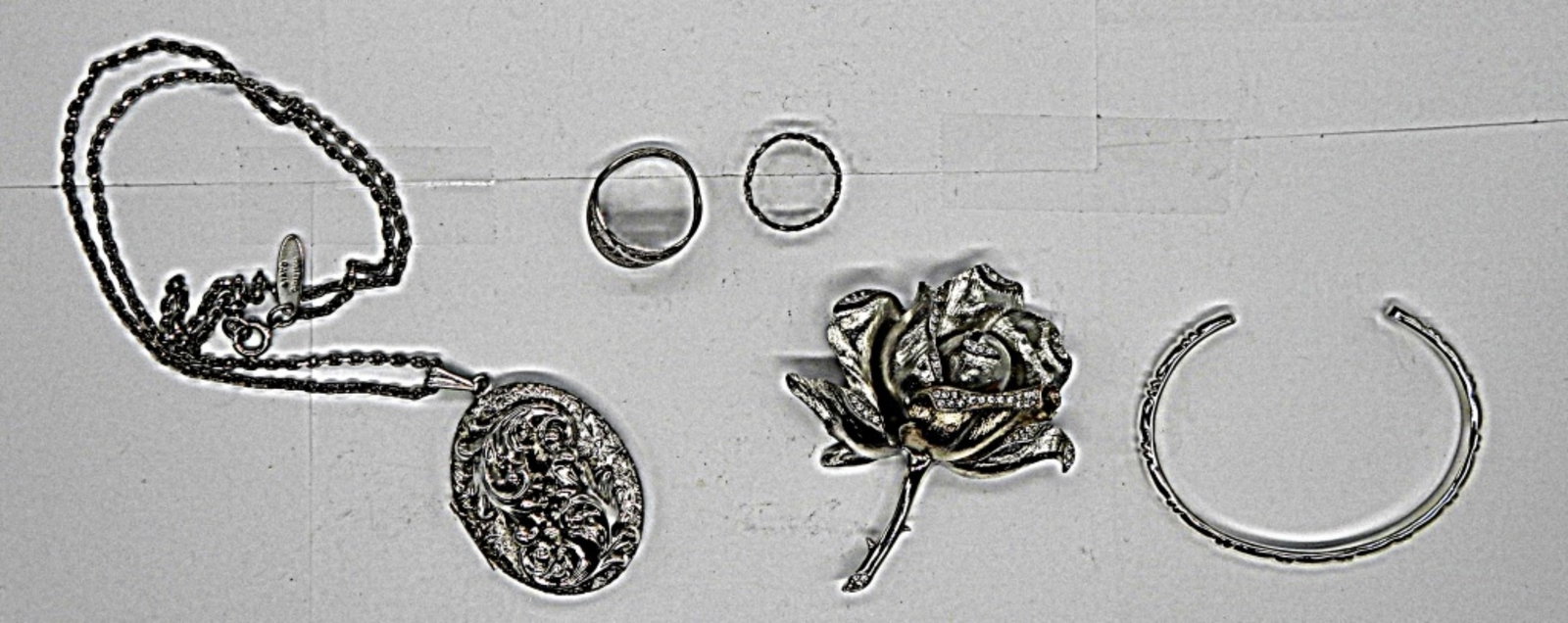 FASHIIN JEWERLY LOT: SARAH COVENTRY RING ADJUSTABLE SIZE SILVER TONE OPEN CUFF BRACLET 26" SILVER TONE NECKLACE WITH LOCKET SILVER TONE FLOWER BROOCH SIZE 6 SILVER TONE RING
