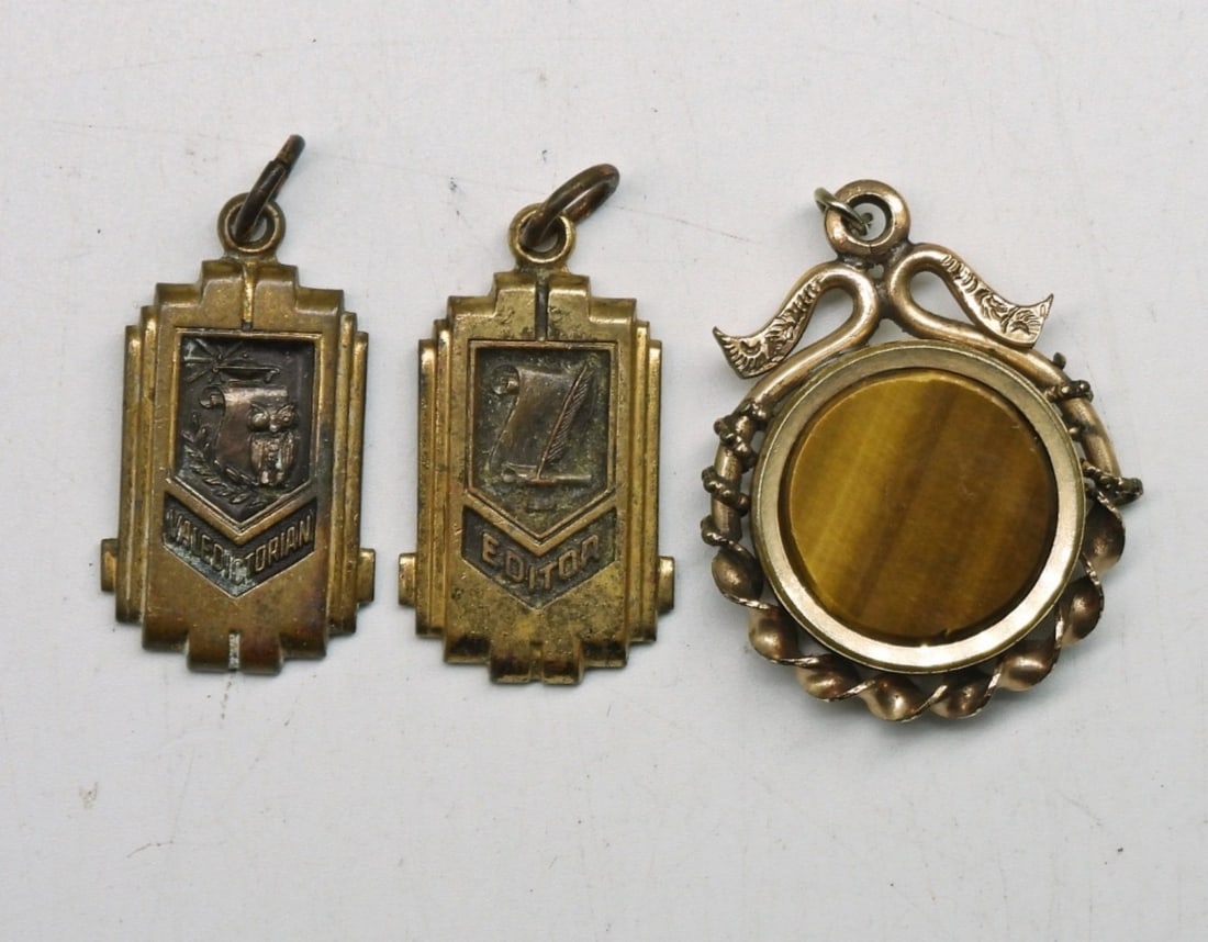 (3) ANTIQUE GOLD TONE PENDANTS: VALEDICTORIAN PENDANT, EDITOR PENDANT & DOUBLE FACE VICTORIAN STYLE PENDANT WITH TIGERS EYE & AN UNKNOWN BLACK GEMSTONE. 1".