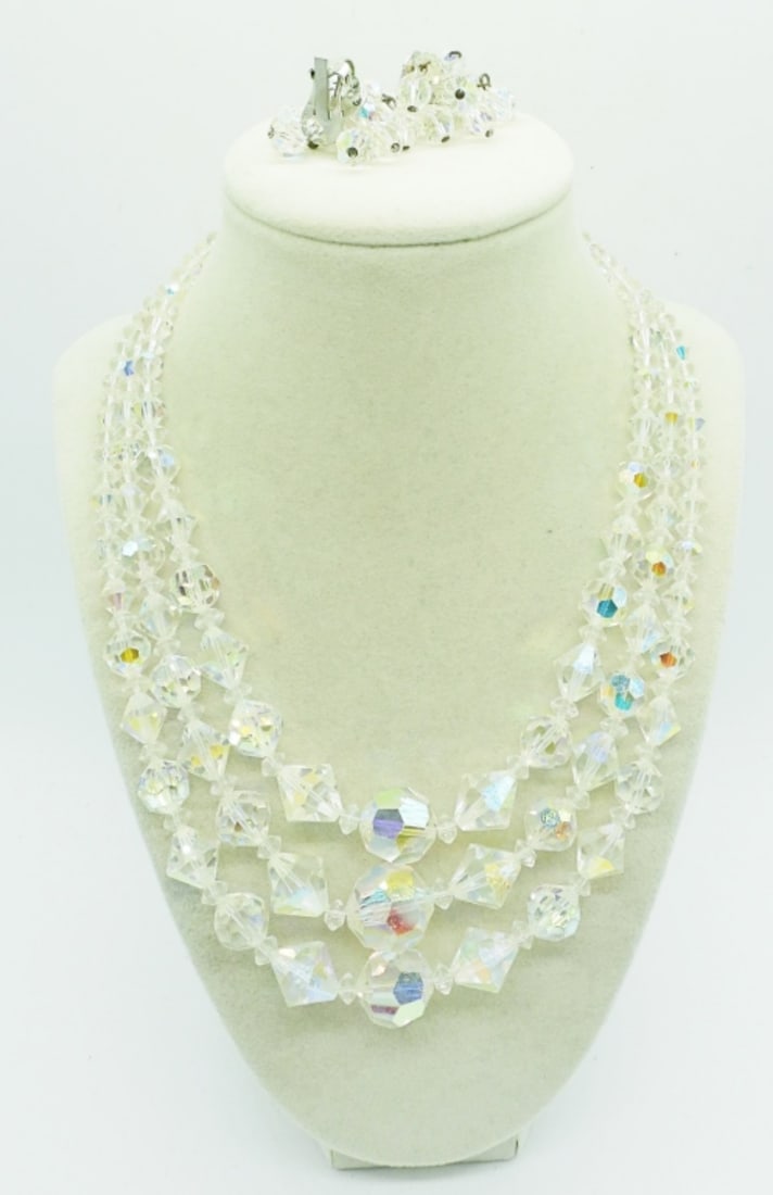 GORGEOUS HEAVY CRYSTAL NECKLACE & EARRINGS: BEAUTIFUL VINTAGE CRYTAL 3 STRAND NECKLACE, VERY HEAVY, 18". CENTER BEAD MEASURES HALF AN INCH! MATCHING VTG CLIP ON EARRINGS.
