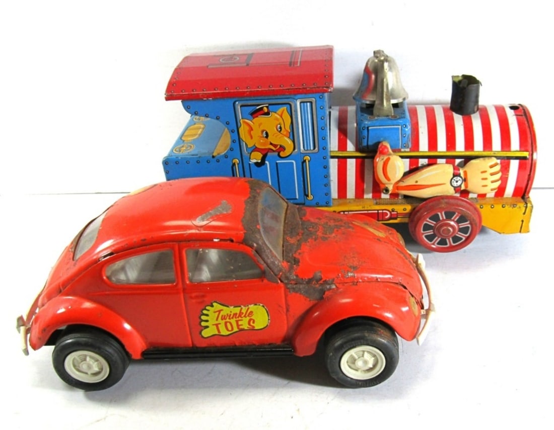 (2) VINTAGE TIN TOYS: 1)CRAGSTAN CHARMING TRAIN, TIN LITHO BATTERY OPERATED (NOT TESTED AS TO WORKING OR NOT!), 10"L, 4.5"HIGH. 2)TONKA TOY 52680 PRESSED STEAL TWINKLE TOES ORANGE BEETLE. SIGNIFICANT RUST.