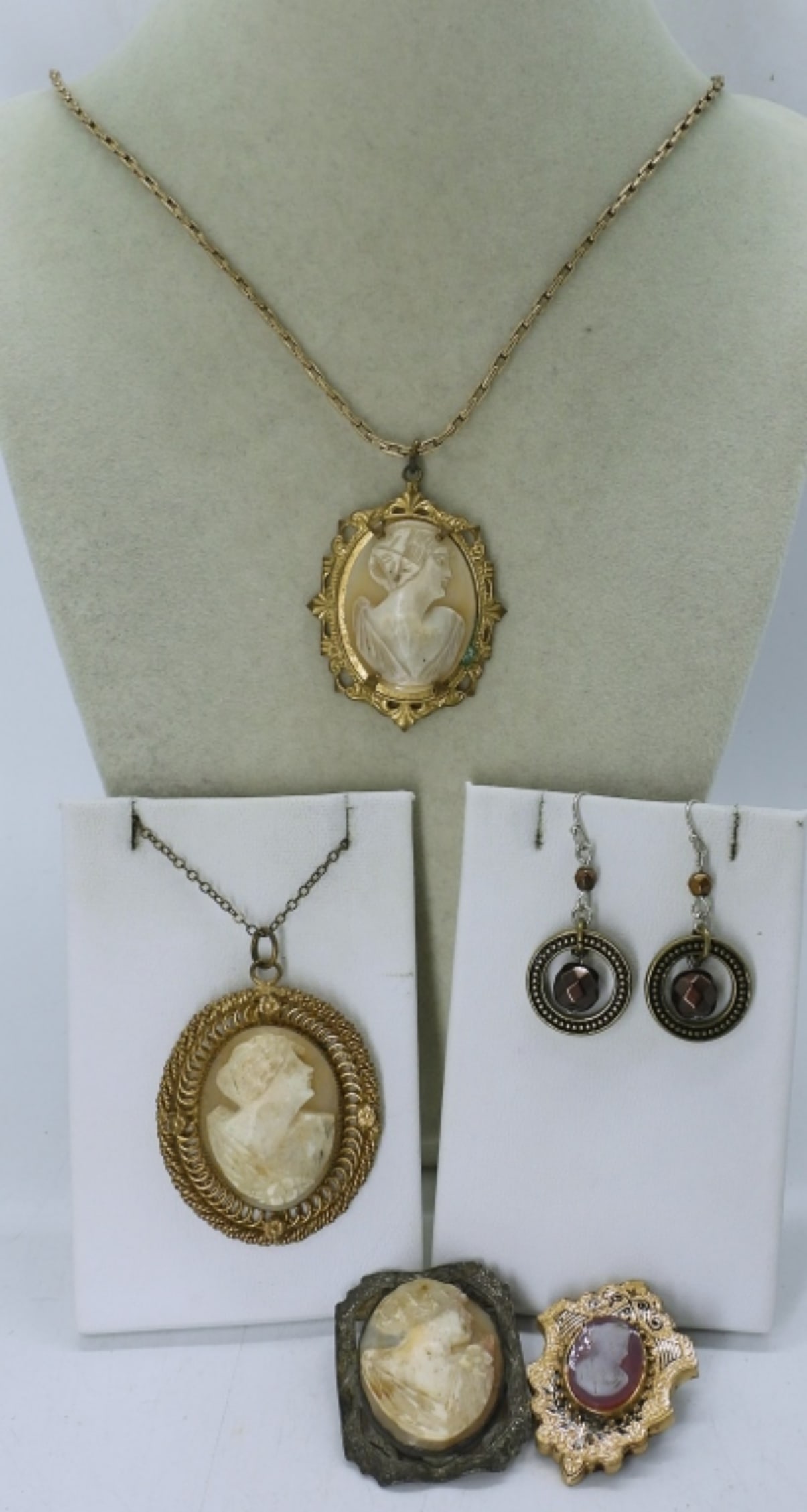 LADIES VINTAGE CAMEO BROOCH LOT: 20" GOLD TONE NECKLACE WITH A CAMEO PENDANT,14" NECKLACE WITH A CAMEO PENDANT, 2 CMAEO BROOCHES AND A PAIR OF EARRINGS
