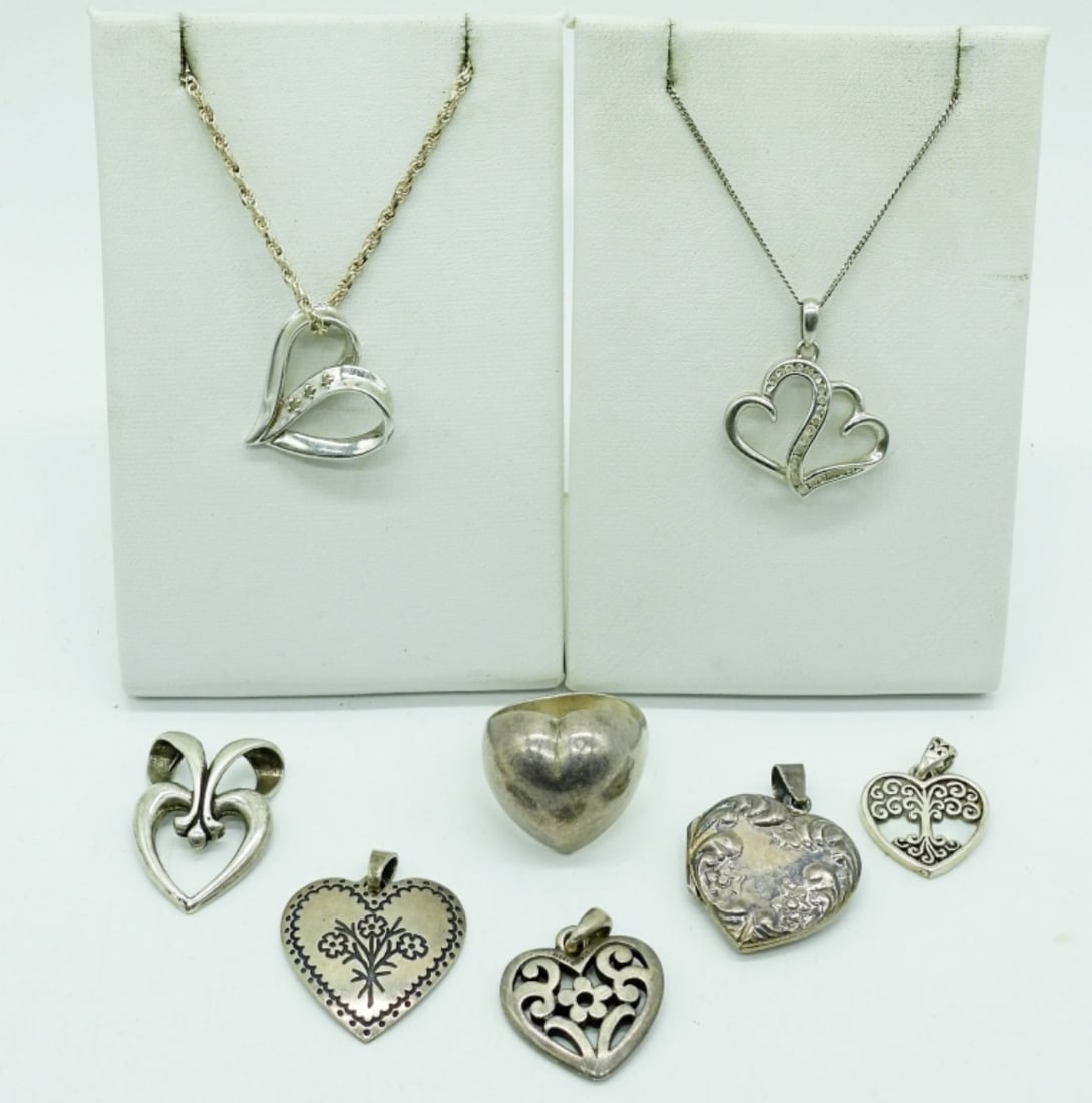 HEART SHAPED PENDANTS - STERLING: 7 STERLING HEART PENDANTS. RING SIZE 8. TWO STERLING CHAINS, 20" & 24". 21.3 DWT