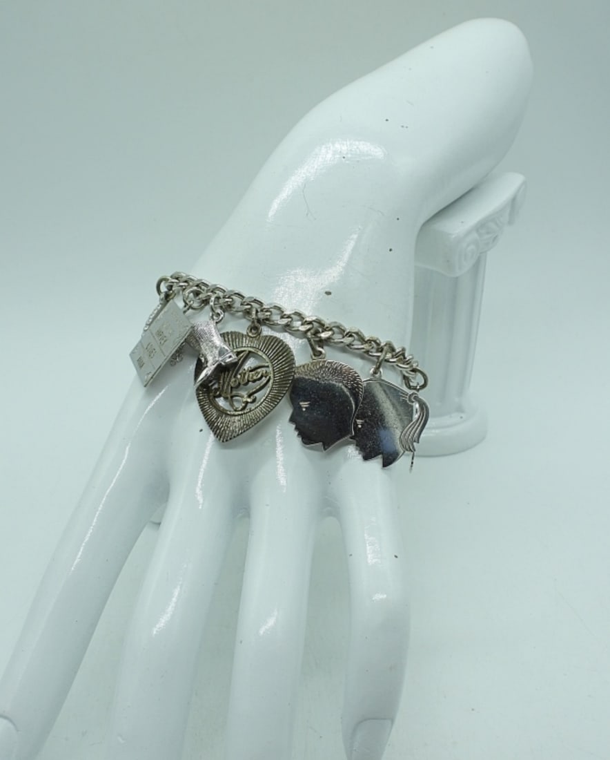 VTG STERLING 10 CHARM BRACELET: VINTAGE STERLING 10 CHARM BRACELET, 7". 27.4 DWT