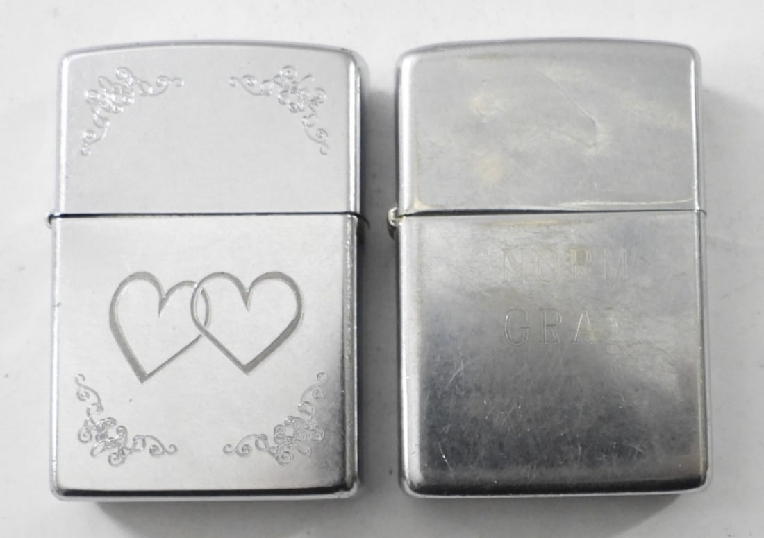 (2) ZIPPOS W DESIGN / ENGRAVING: (2) ZIPPOS W DESIGN / ENGRAVING, 2007 FIRED DOUBLE HEARTS DESIGN, 1978 FIRED SILVERTONE ENGRAVED W "NORM GRAY" ON FRONT, "LOVE BETTY" ON BACK