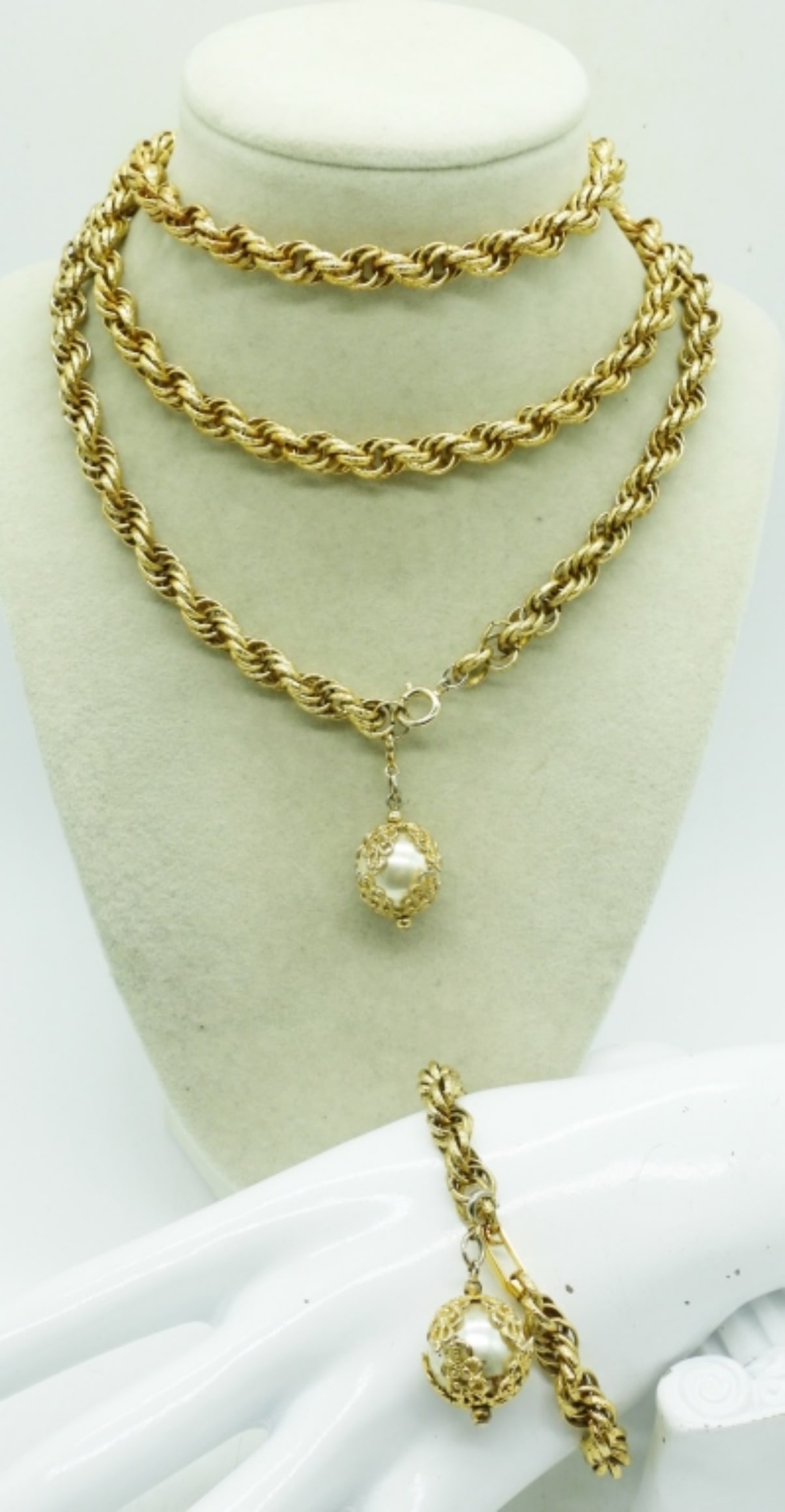 CELEBRITY BRAND GOLD TONE PEARL SET: CELEBRITY BRAND, LONG GOLD TONE CHAIN WITH FAUX PEARL WITH FILIGREE WORK. NECKLACE IS 40". MATCHING BRACELET IS 7".