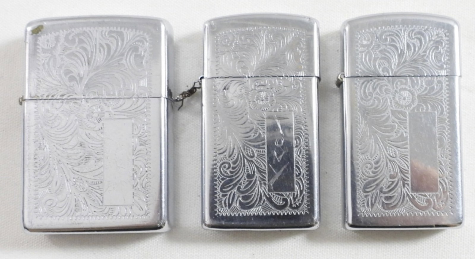 (3) VENETIAN SCROLL MONOGRAM ZIPPO's: (2) SLIM with one missing pin (1) REG SIZE - ALL FIRED