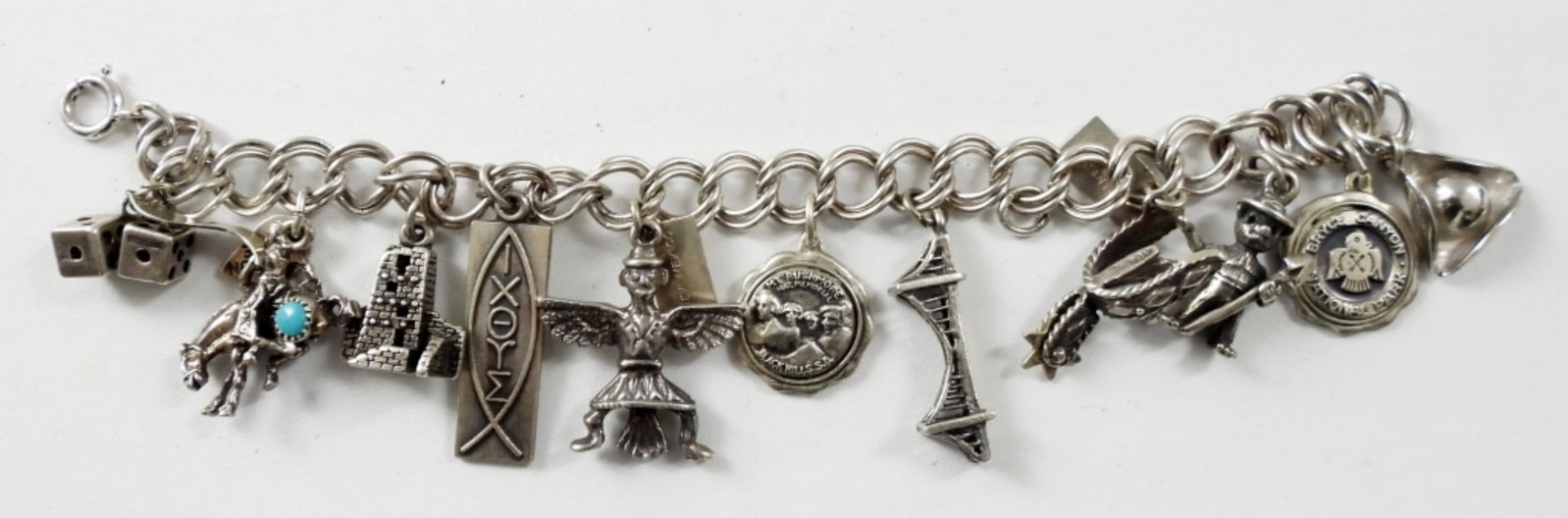 STERLING CHARM BRACELET: 25.6 DWT, 11 CHARMS ALL MARKED STERLING, BRACELET MARKED STERLING AT CLASP 6IN LONG