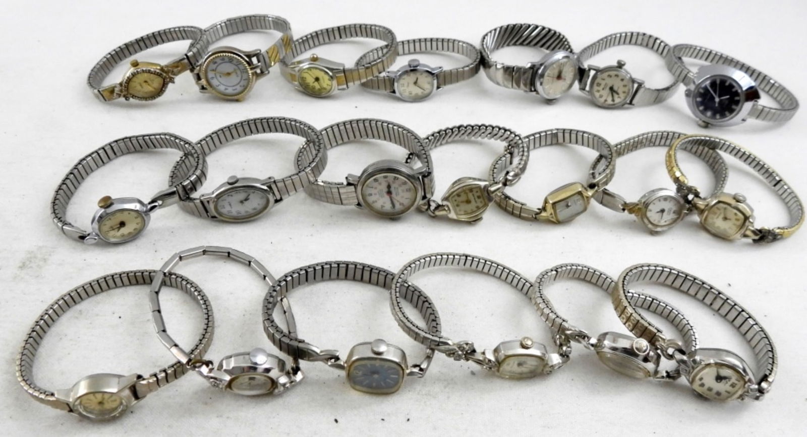 (20) SILVERTONE STRETCH BAND WATCHES: 20 WOMEN'S STRETCH BAND BRACELET WATCHES, SILVER TONE. BULOVA, TIMEX, WALTHAM, WYLER, & MORE-NOT TESTED AS TO WORKING OR NOT-