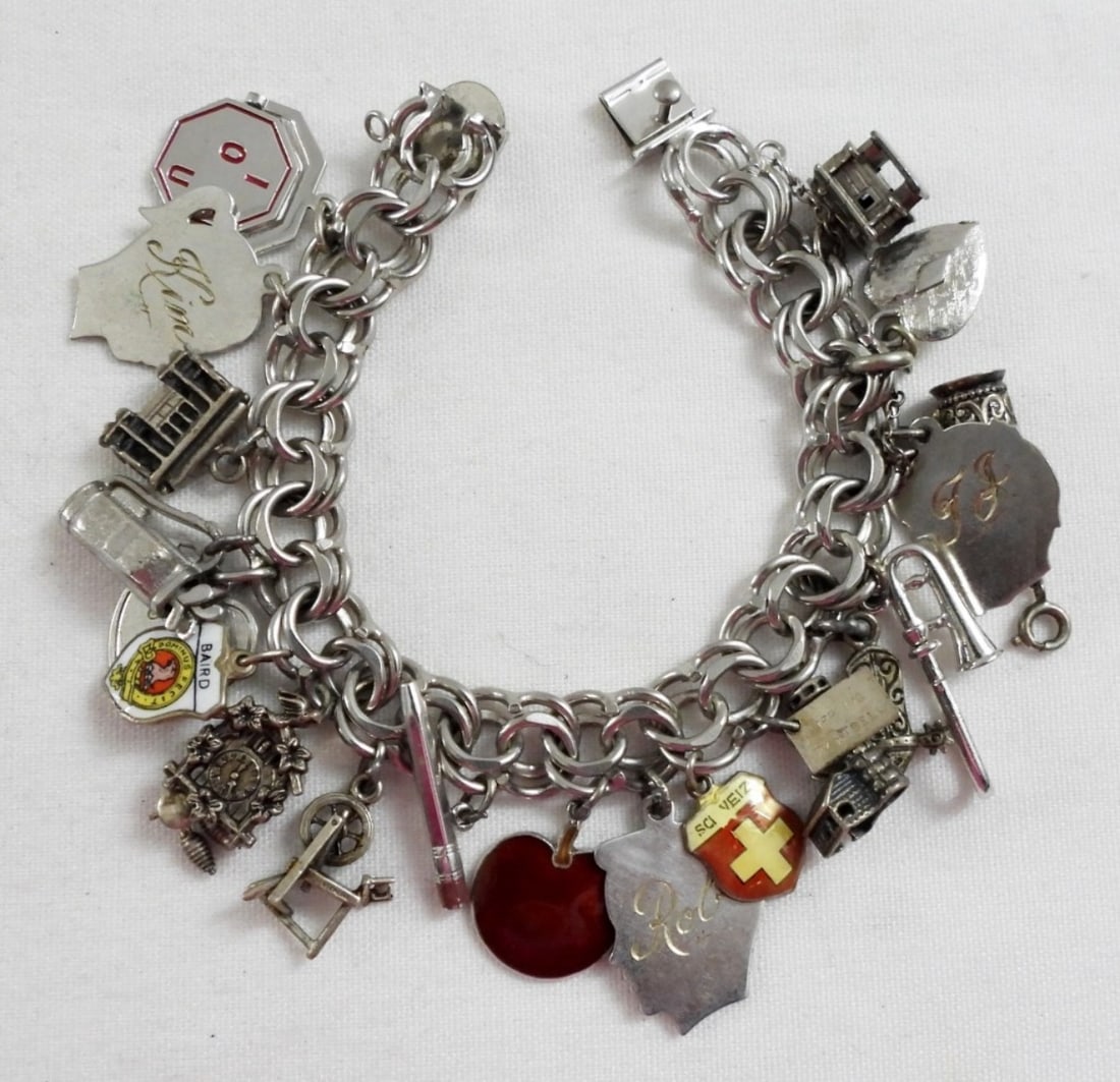 STERLING CHARM BRACELET: 41DWT, NEARLY 8IN LONG WITH BOX CLASP, WITH 19 CHARMS MOST ARE MARKED WITH STERLING OR 925
