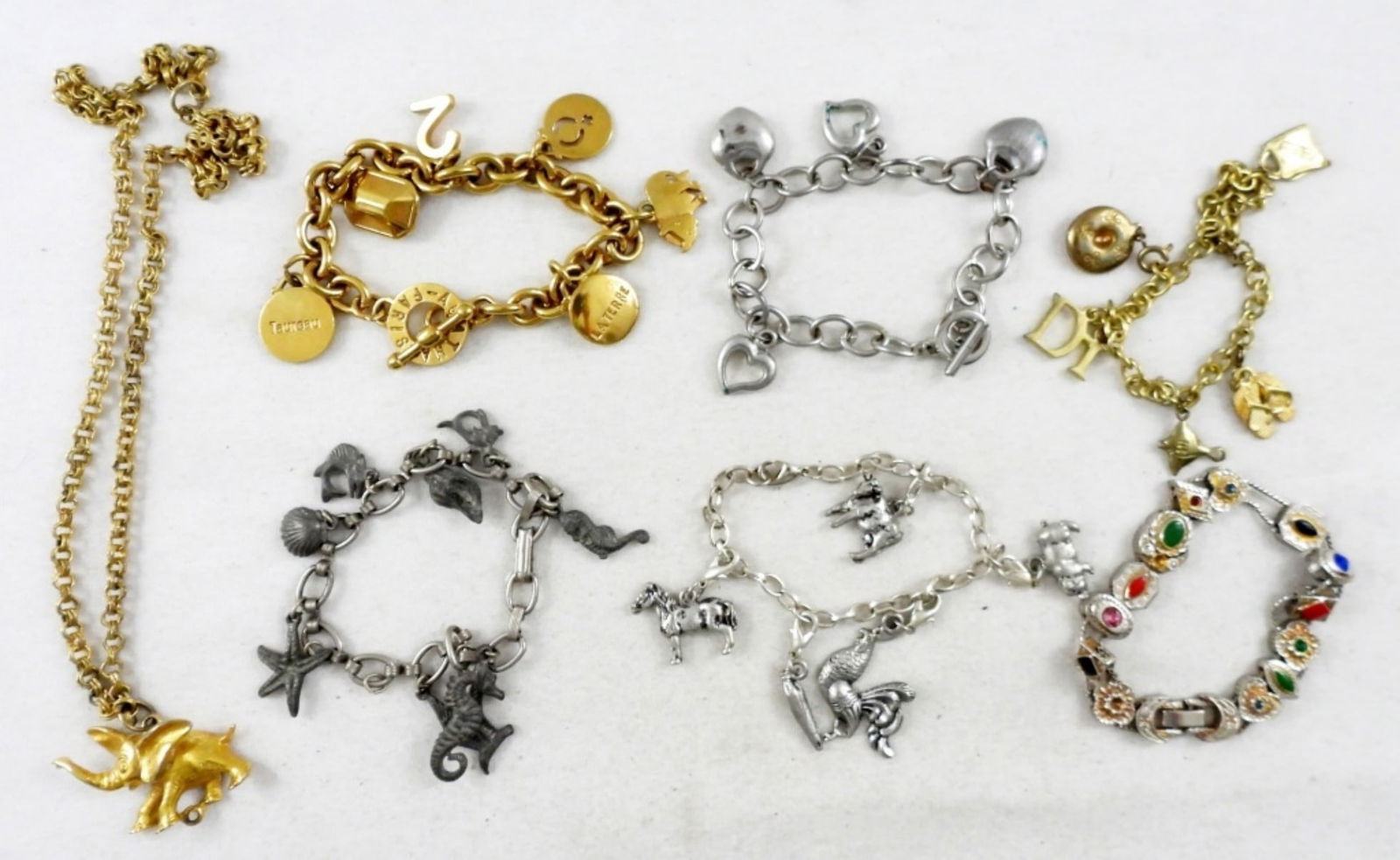 6 CHARM BRACELETS & ELEPHANT NECKLACE: 6 VARIETY OF CHARM BRACELETS AND 1 GOLD TONE ELEPHANT PENDANT ON CHAIN