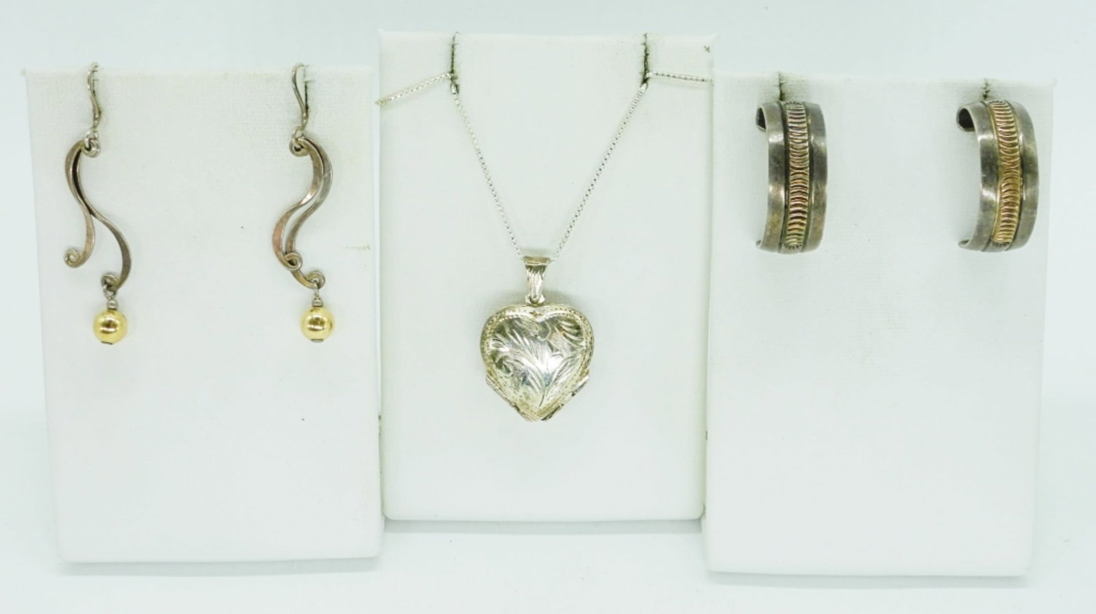 925 HEART LOCKET, PIERCED EARRINGS: TARNISHED STERLING HEART LOCKET ON A 24" CHAIN. TWO PAIR OF STERLING PIERCED EARRINGS. 14 DWT