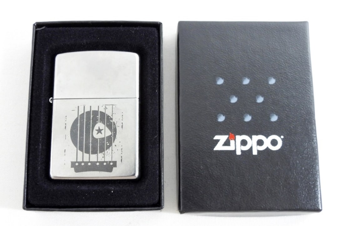 RETRO GUITAR INSPIRED ZIPPO- 2008: 2008 RETRO GUITAR INSPIRED ZIPPO- UNFIRED- IN GOOD CONDITION. DOES COME WITH A BLACK ZIPPO BOX THAT IS IN GOOD CONDITION. PREOWNED.