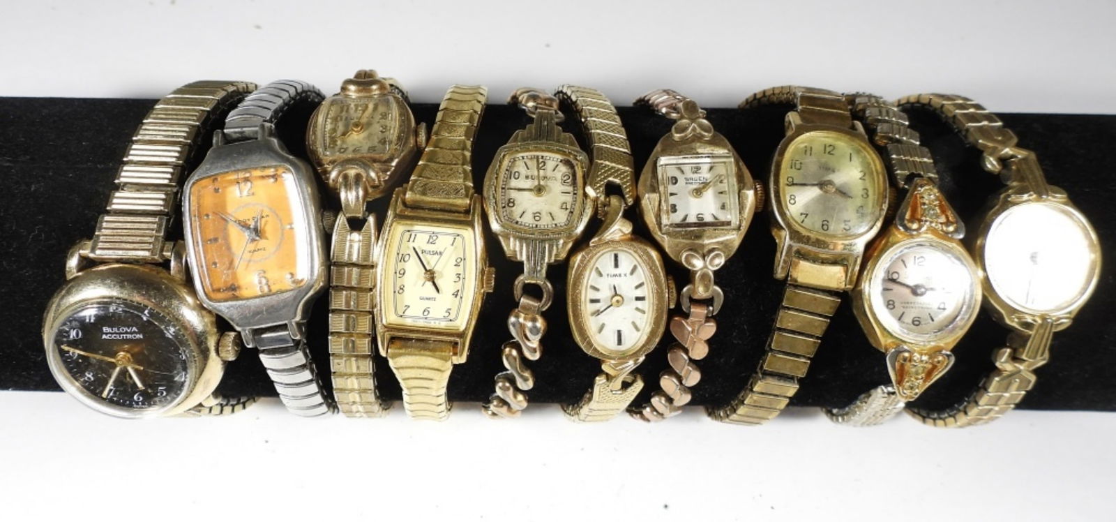 (10) WOMEN'S STRETCH BAND WATCHES: 10 WOMEN'S STRECH BAND WATCHES- IN SILVER AND GOLD TONES- SOME WITH RHINESTONE ACCENTS- SOME OF THE BRANDS ARE TIMEX, BULOVA, GRUEN, PULSAR- THESE BRANDS ARE UNSEARCHED AND UNVERIFIED. THESE WATCHES D