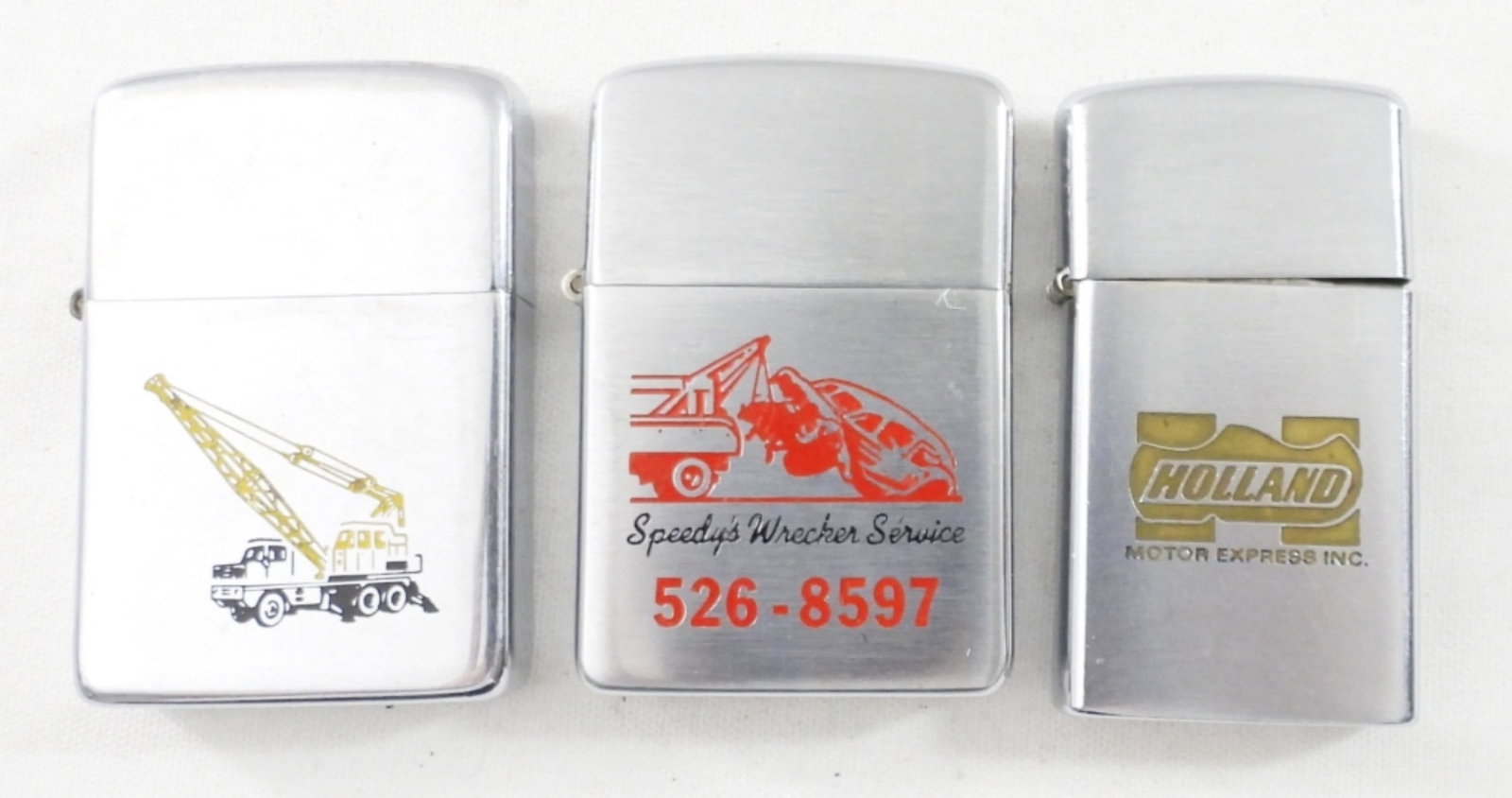 (3) ADVERTISING VTG LIGHTERS - ERECTING: NEWTON ERECTING CO, SPEEDY'S WRECKER SERVICE unfired!!, HOLLAND MOTOR EXPRESS - (2) FIRED (1) UNFIRED