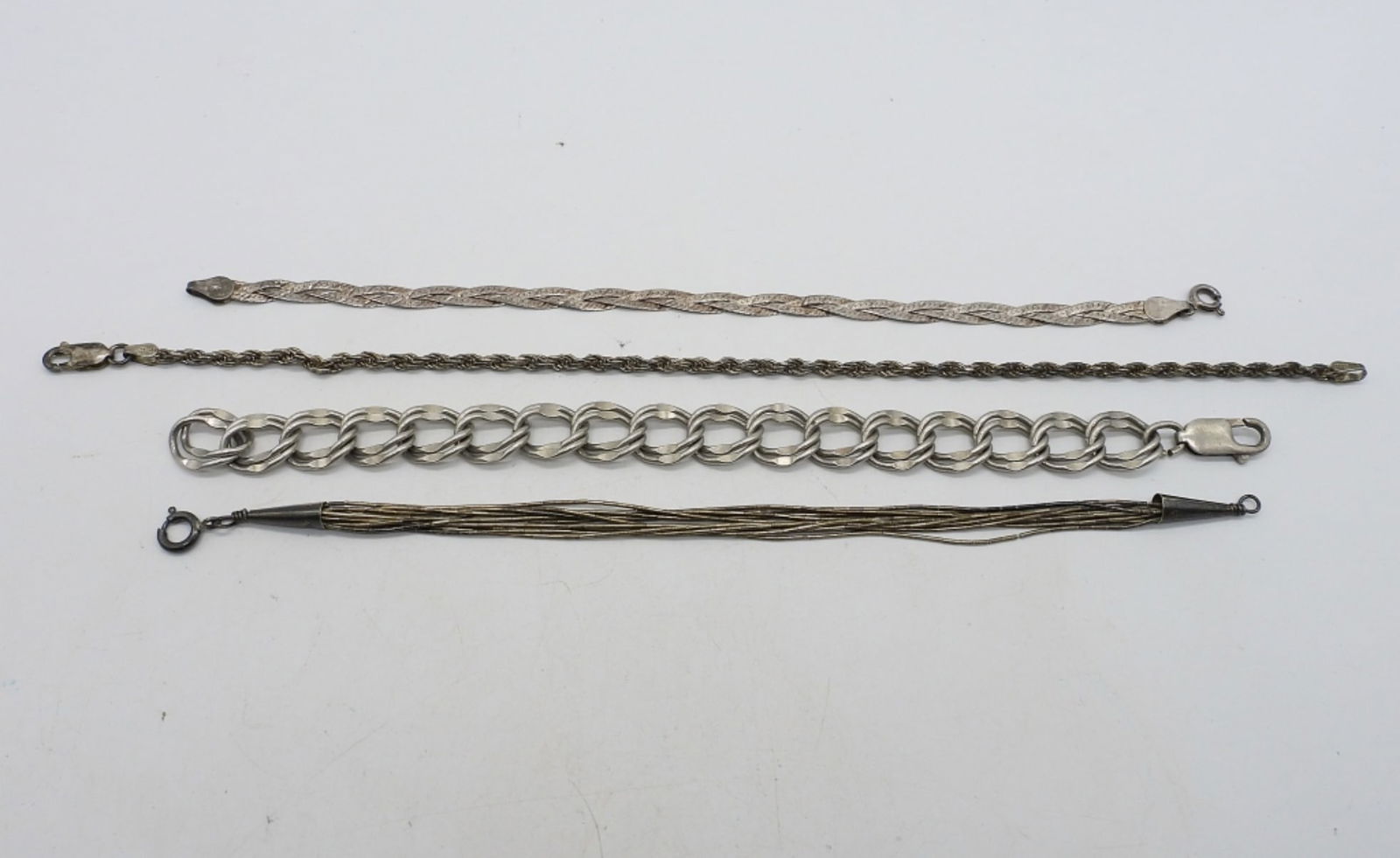 (4) STERLING CHAIN BRACELETS - LIQUID STERL: FOUR STERLING CHAIN BRACELETS. 7-8". (17.6 DWT)