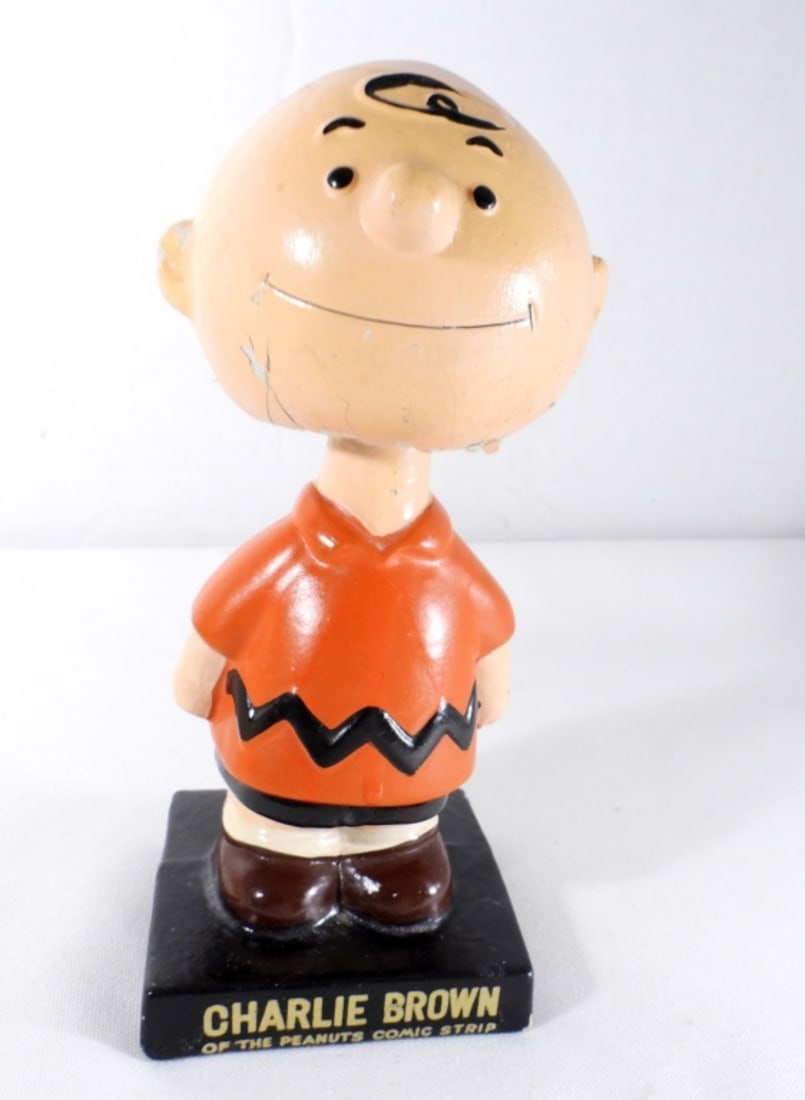 1964 VINTAGE CHARLIE BROWN LEGO BOBBLEHEAD: 1964 VINTAGE CHARLIE BROWN BOBBLE HEAD, MISSING HIS HAT, WEAR AND CRACKS ON THE BOTTOM OF THE HEAD AND EARS, MARKING ON THE BOTTOM OF BASE