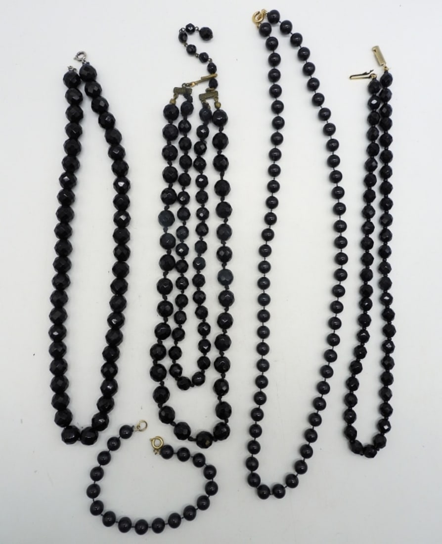 VINTAGE BLACK NECKLACES & BRACELET: FOUR VINTAGE BLACK NECKLACES AND ONE VINTAGE MATCHING BLACK BRACELET. NECKLACES ARE 18", 19", 24". BRACELET IS 7"