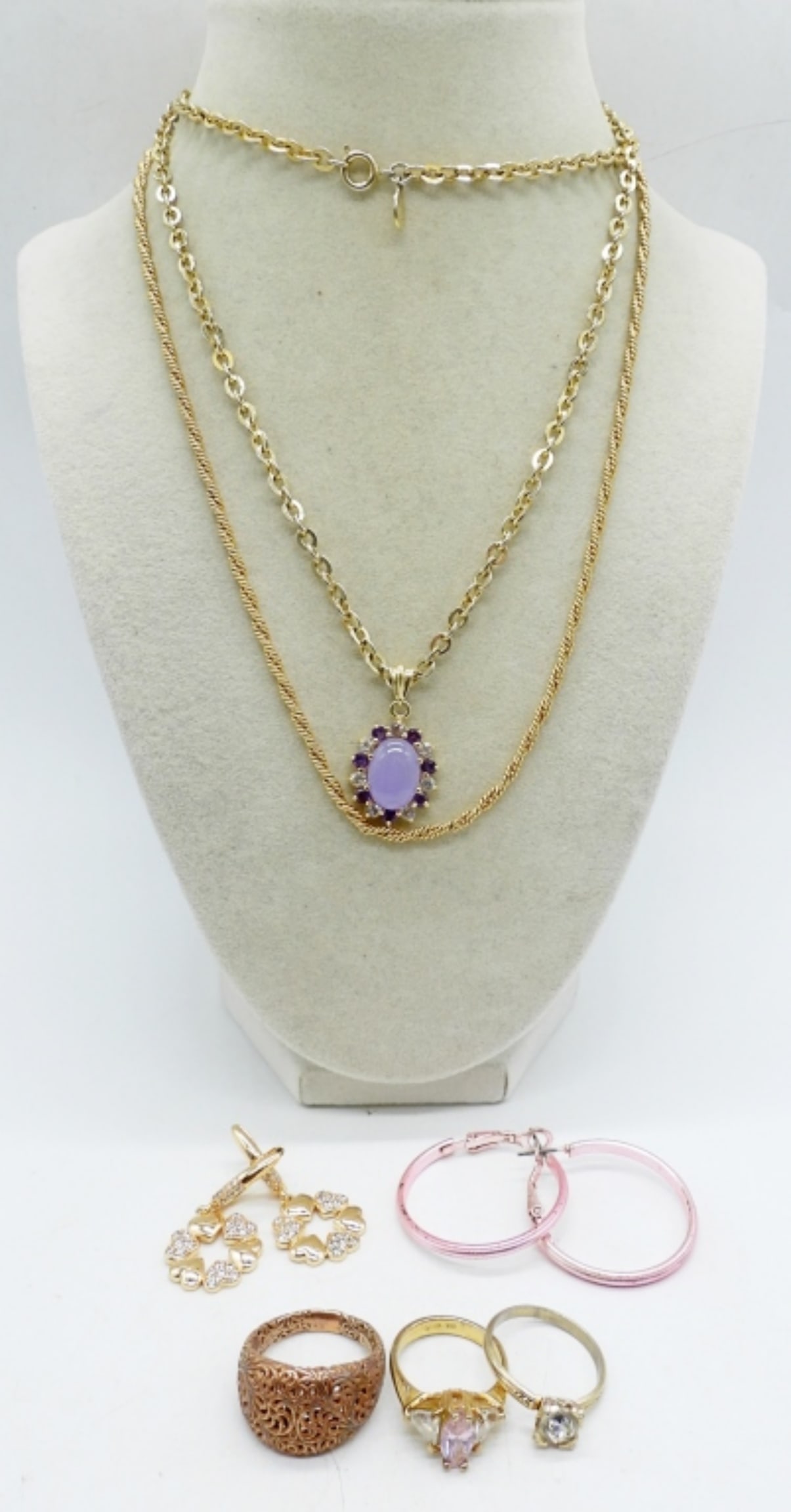 AVON, NECKLACES, RINGS, EARRINGS: 1 AVON PURPLE GEMSTONE NECKLACE, 28". GOLD TONE CHAIN, 18". TWO PAIR OF PIERCED EARRINGS. THREE RINGS, SIZES 6 & 8.