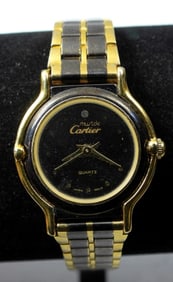BLACK AND GOLD TONE CARTIER WATCH