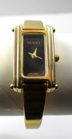 BLACK AND GOLD TONE GUCCI WATCH